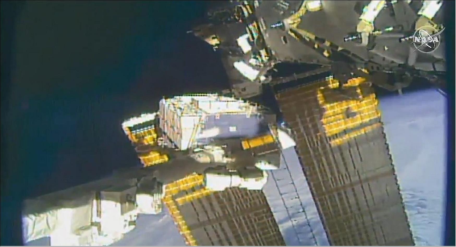 Figure 7: NASA astronaut pictured tethered on the space station’s truss structure during a spacewalk to swap batteries and route cables (image credit: NASA TV)