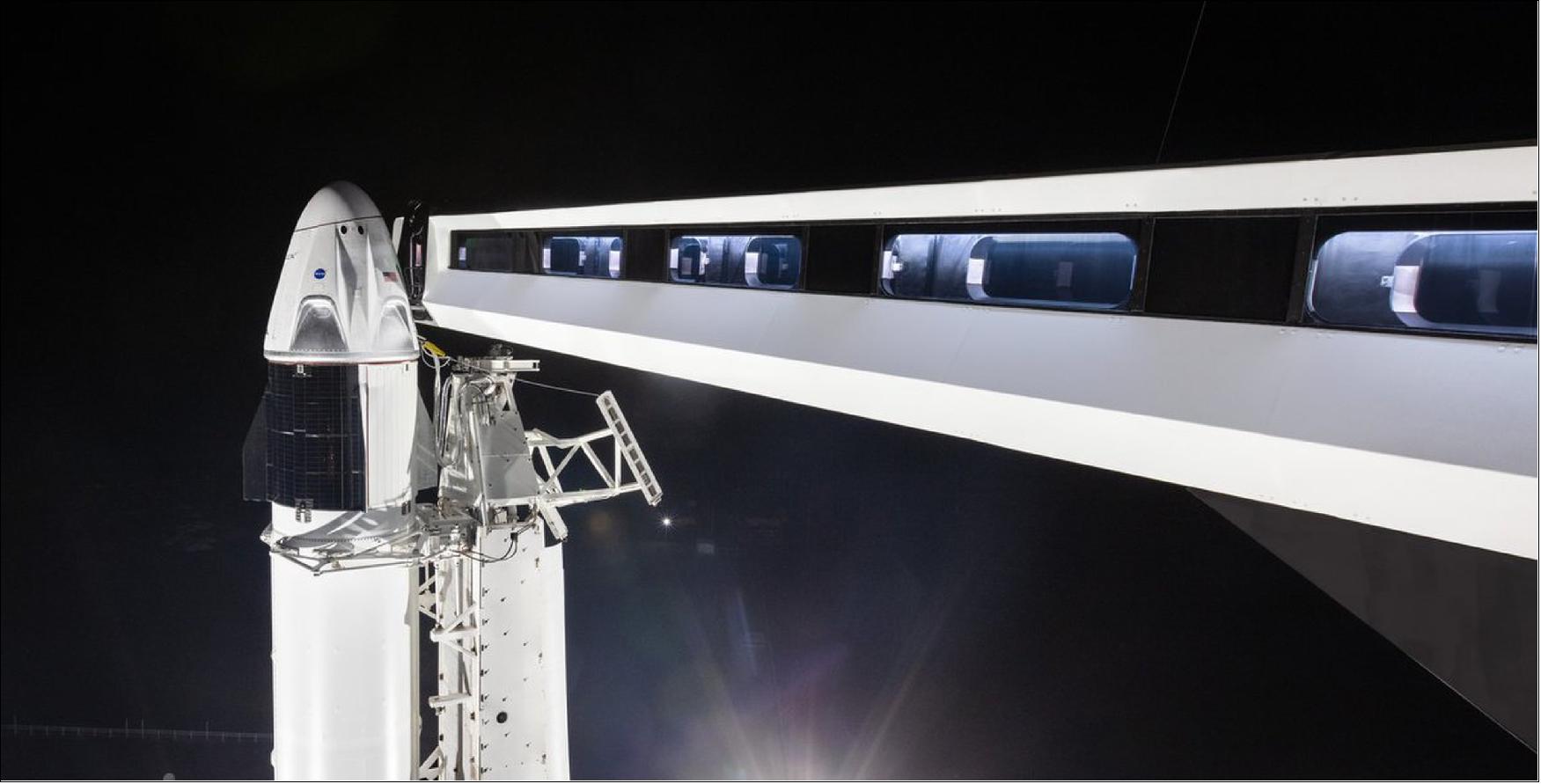 Figure 29: A crew access arm reaches toward SpaceX's first Crew Dragon spacecraft atop its Falcon 9 rocket on Launch Pad 39A of NASA's Kennedy Space Center in Cape Canaveral, Florida on Jan. 3, 2019 ahead of an uncrewed test flight (image credit: SpaceX)