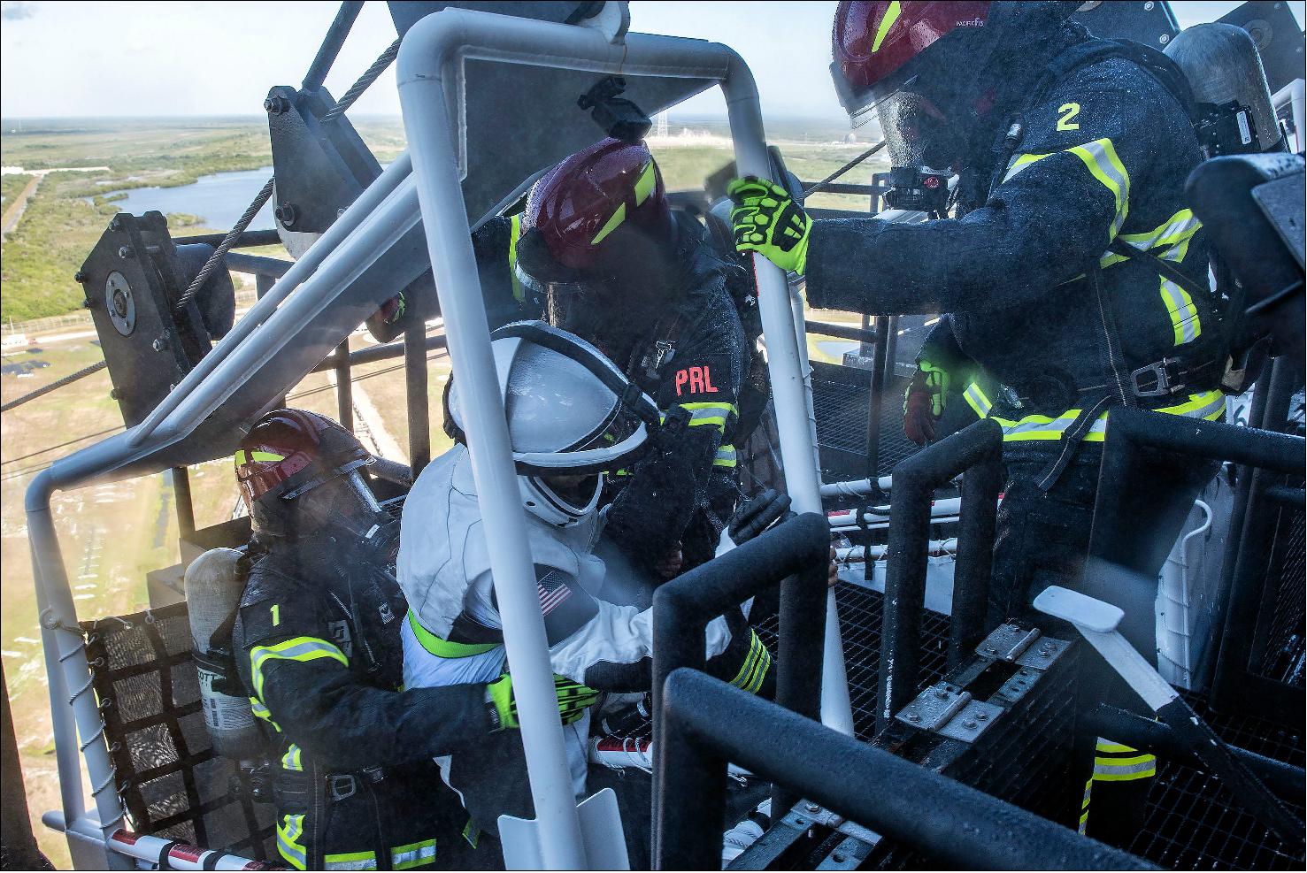 Figure 20: Photo of the pad’s slidewire basket with the rescue team (photo credit: SpaceX)