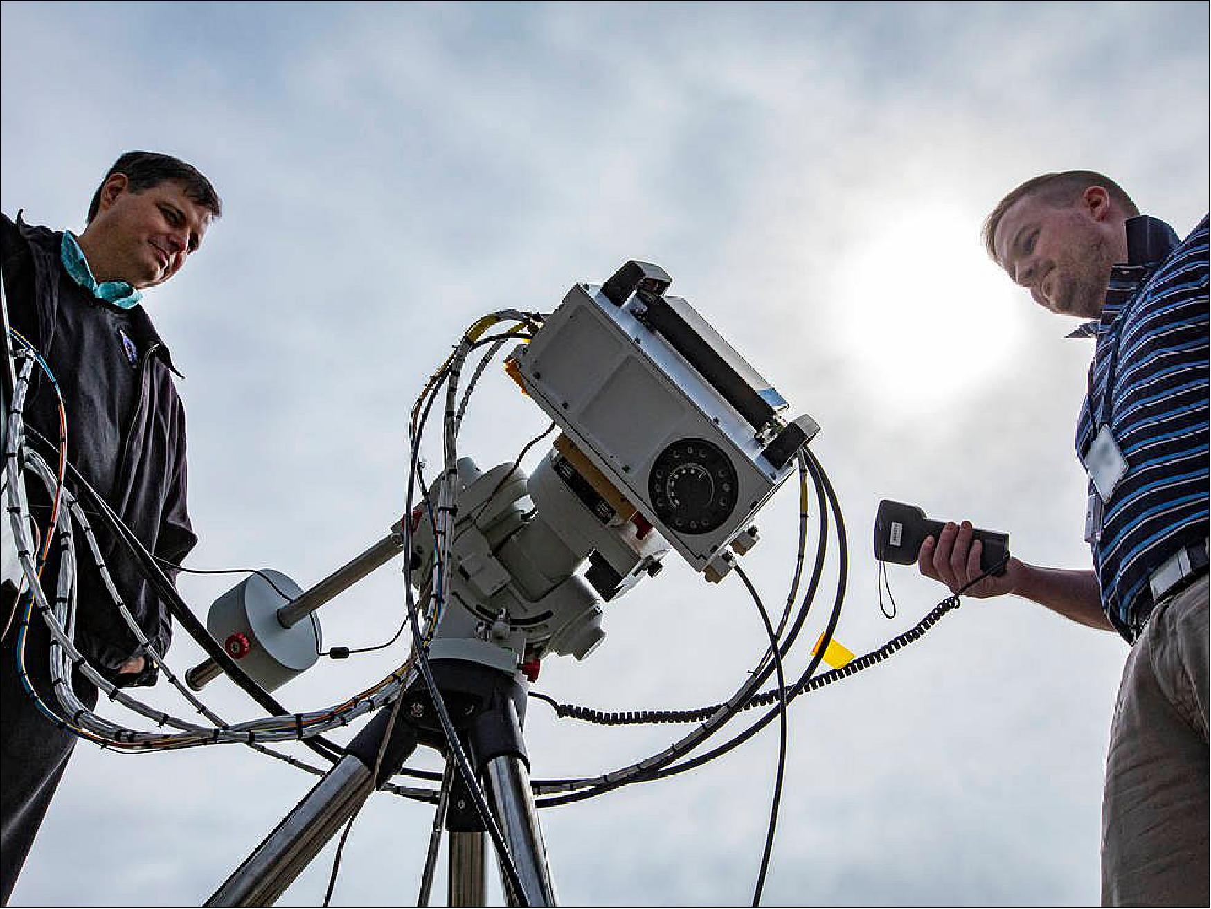 Figure 2: Charles Hill, left, and John Leckey with the Stratospheric Aerosol and Gas Experiment (SAGE) IV Pathfinder instrument during Sun-look testing at NASA's Langley Research Center (image credits: NASA/David C. Bowman)