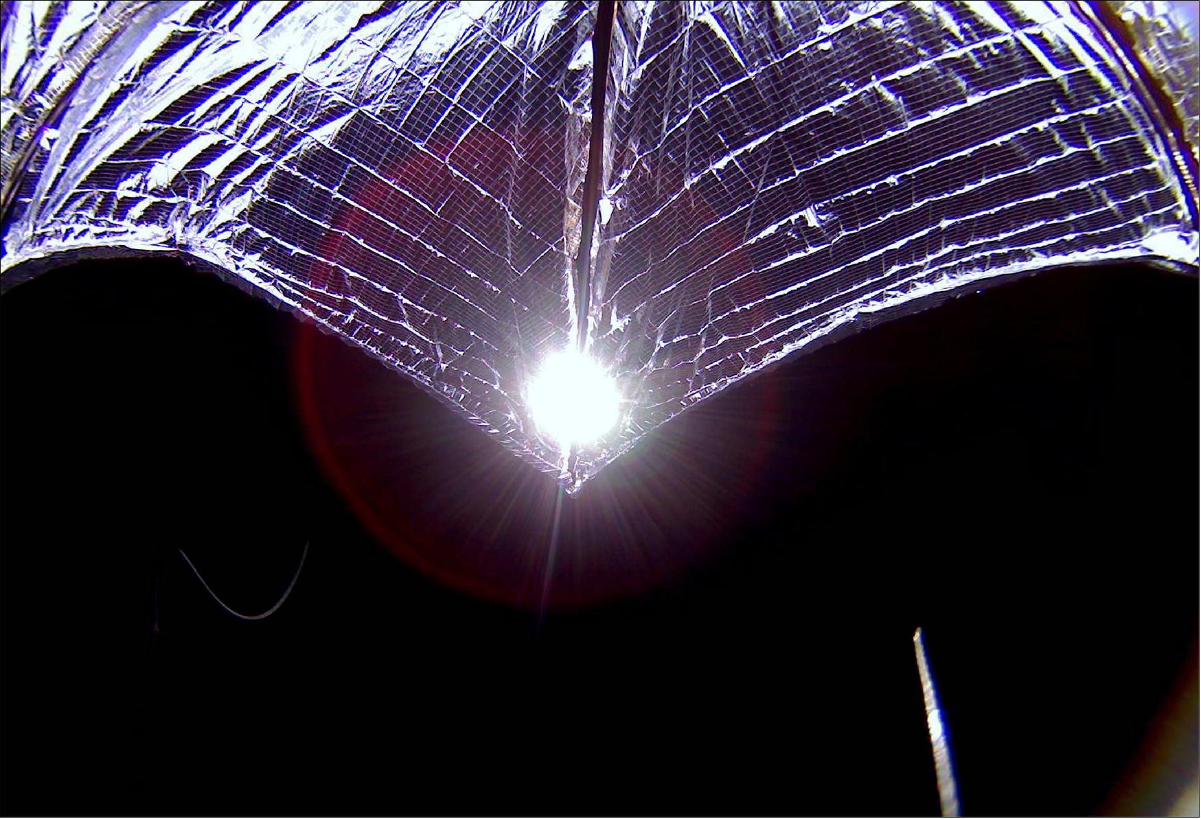 Figure 13: On Monday (29 July), LightSail-2 sent home a new full-resolution image captured by its camera during solar sail deployment. The perspective is opposite to last week’s full-resolution image and shows the sail more fully deployed. LightSail-2's aluminized Mylar sail shines against the blackness of space, with the Sun peeking through near a sail boom (image credit: The Planetary Society)