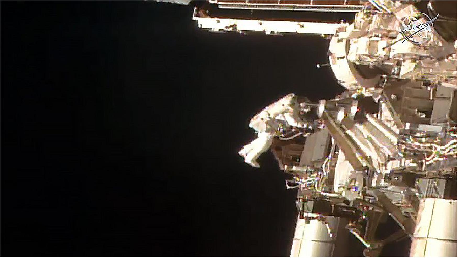 Figure 13: NASA astronaut Bob Behnken is pictured tethered to the space station during a spacewalk to swap batteries on the orbiting lab's truss structure (image credit: NASA TV)