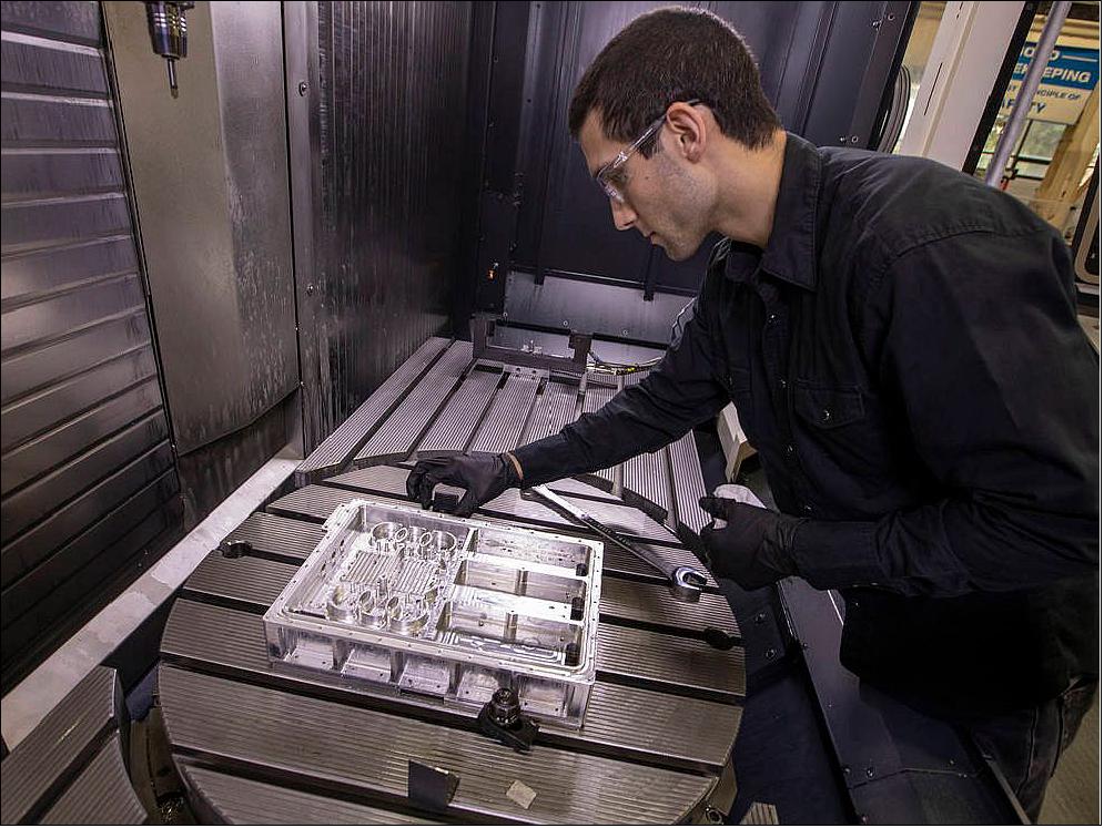 Figure 10: Langley engineer John Savage inspects a section of the navigation Doppler lidar unit after its manufacture from a block of metal (image credits: NASA/David C. Bowman)