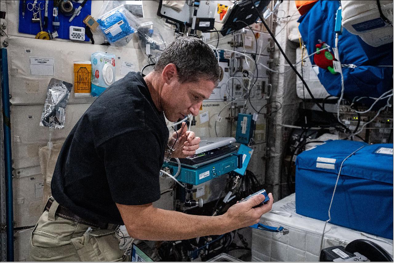 Figure 14: Preparing Rotifer-2 experiment. NASA astronaut and Expedition 64 Flight Engineer Michael Hopkins shakes an experiment container containing biological samples to displace bubbles before placing it into the Kubik incubator facility. Hopkins was servicing the samples for the Rotifer-B2 experiment that is exploring the effects spaceflight has on DNA repair mechanisms of the bdelloid rotifer Adineta vaga, a plankton-like microscopic organism (image credit: NASA)