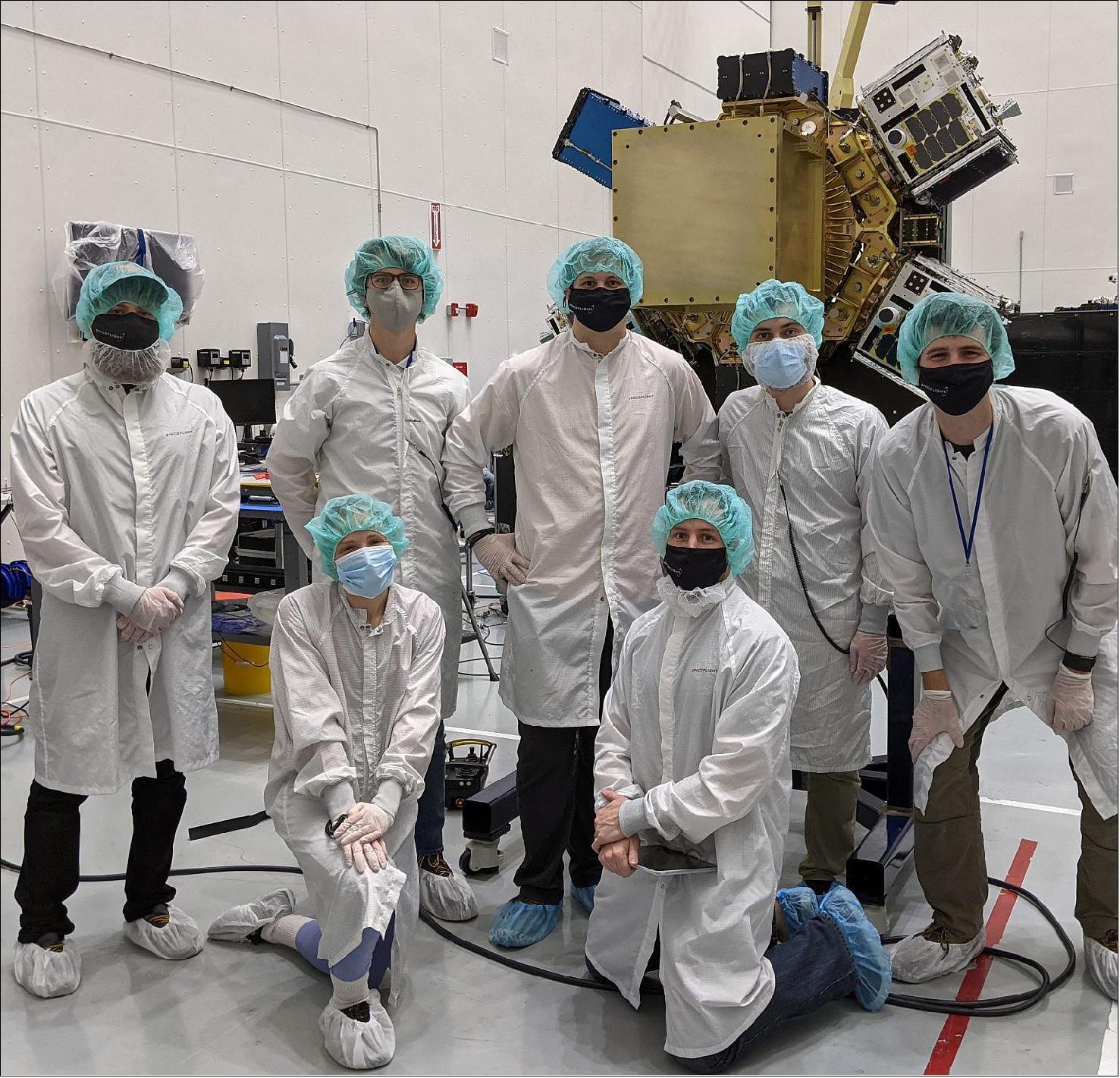 Figure 8: Spaceflight Inc. integration team (with the Sherpa-FX OTV in the background) at the SpaceX Payload Processing Facility at Cape Canaveral Space Force Station. Back row: M. Coletti, A. Lewandowski, J. Larkin, M. Foster, M. Boysen Front row: A. Taylor, R. Olcott (image credit: Spaceflight)