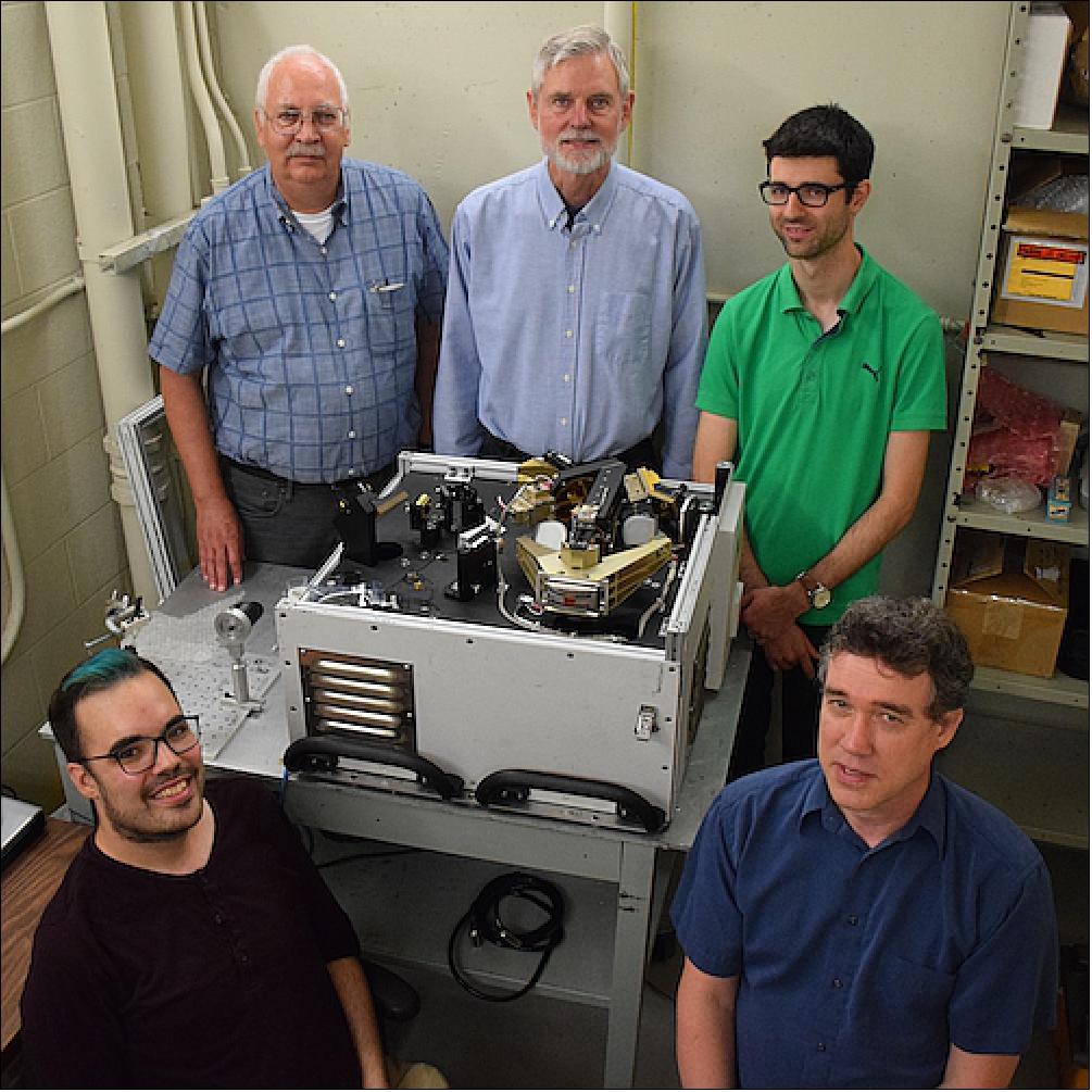 Figure 8: The ACE Team poses with a copy of the ACE instrument. Left to Right back: Peter Bernath, Dennis Cok, and Scott Jones; Left to Right front: Johnny Steffen and Chris Boone (image credit: University of Waterloo)