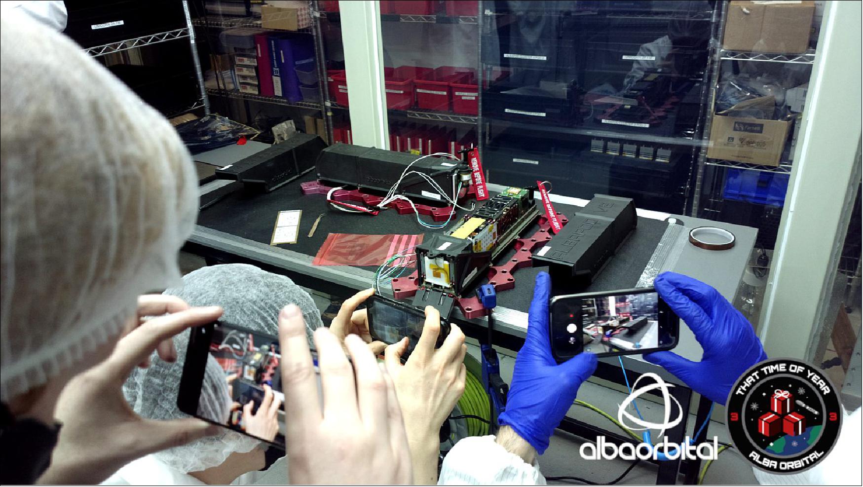 Figure 10: Camera gather round to capture this historic event in PocketQube history (image credit: Alba Orbital)
