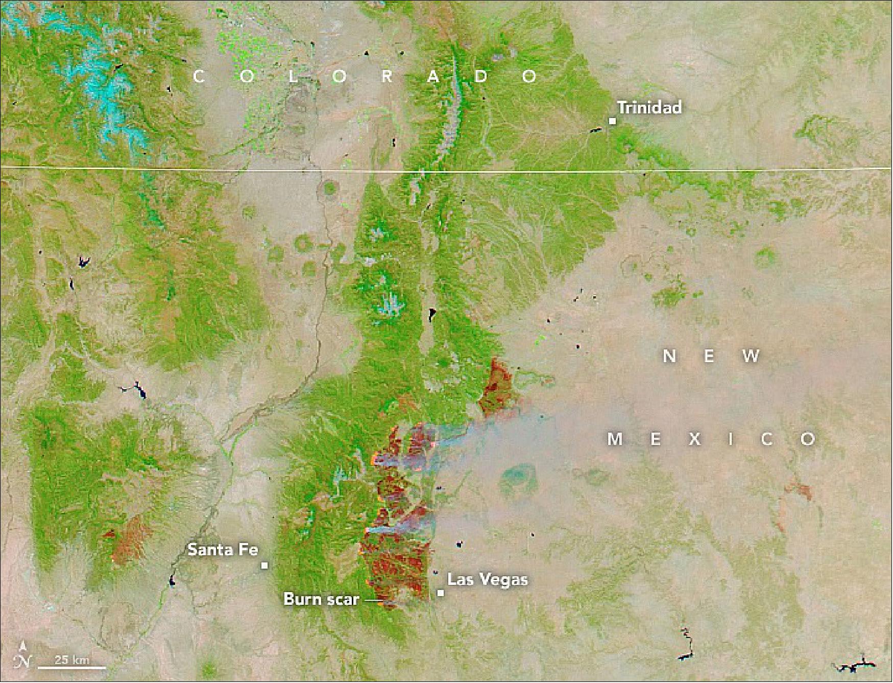 Figure 17: This false-color image was acquired on May 12, 2022, by MODIS-Aqua. The use of shortwave infrared and visible light (bands 7-2-1) shows the burn scars (in red) from three major fires burning in northern New Mexico. The largest scar, in the center of the image, is from the Calf Canyon-Hermits Peak fire. To the west of Santa Fe is the Cerro Pelado burn scar. The scar to the northeast is from the Cooks Peak fire (image credit: NASA Earth Observatory)