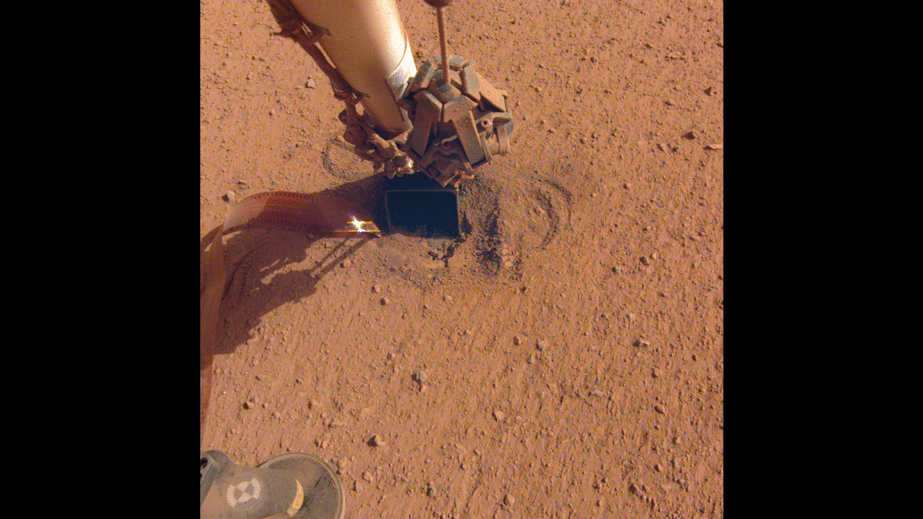 Figure 28: NASA's InSight retracted its robotic arm on Oct. 3, 2020, revealing where the spike-like "mole" is trying to burrow into Mars. The copper-colored ribbon attached to the mole has sensors to measure the planet's heat flow. In the coming months, the arm will scrape and tamp down soil on top of the mole to help it dig (image credit: NASA/JPL-Caltech)