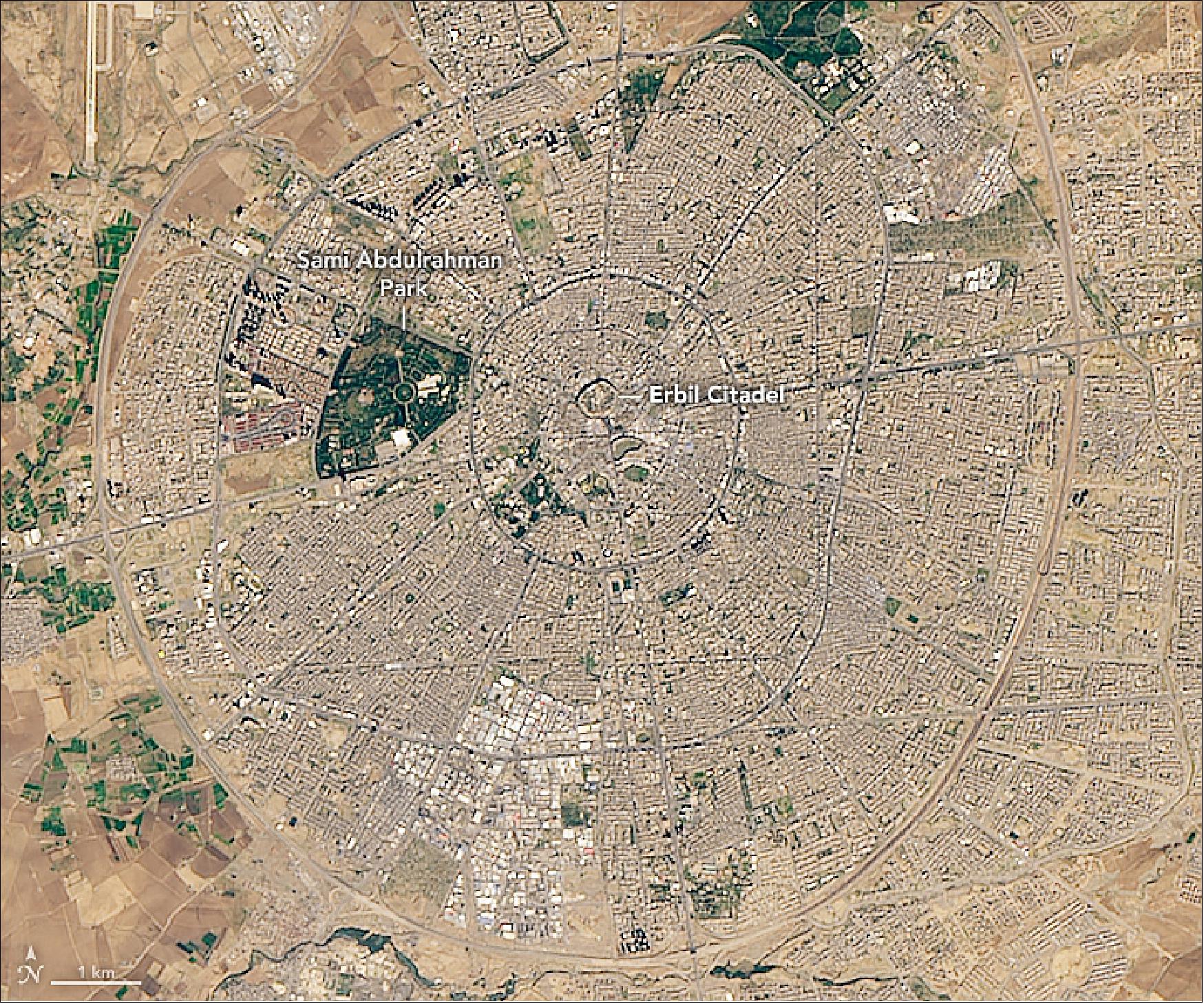 Figure 89: This image of Erbil Citadel and its surroundings was acquired on November 20, 2018, by OLI on the Landsat-8 satellite. From above, Erbil Citadel appears at the center of what looks like a wagon wheel—perhaps more than a coincidence, as evidence suggests humans may have been living there during the Ubaid period, when humans invented the wheel. The Citadel is surrounded by the capital of the Iraqi Kurdistan autonomous region (image credit: NASA Earth Observatory, image by Lauren Dauphin, using Landsat data from the U.S. Geological Survey. Story by Kasha Patel)