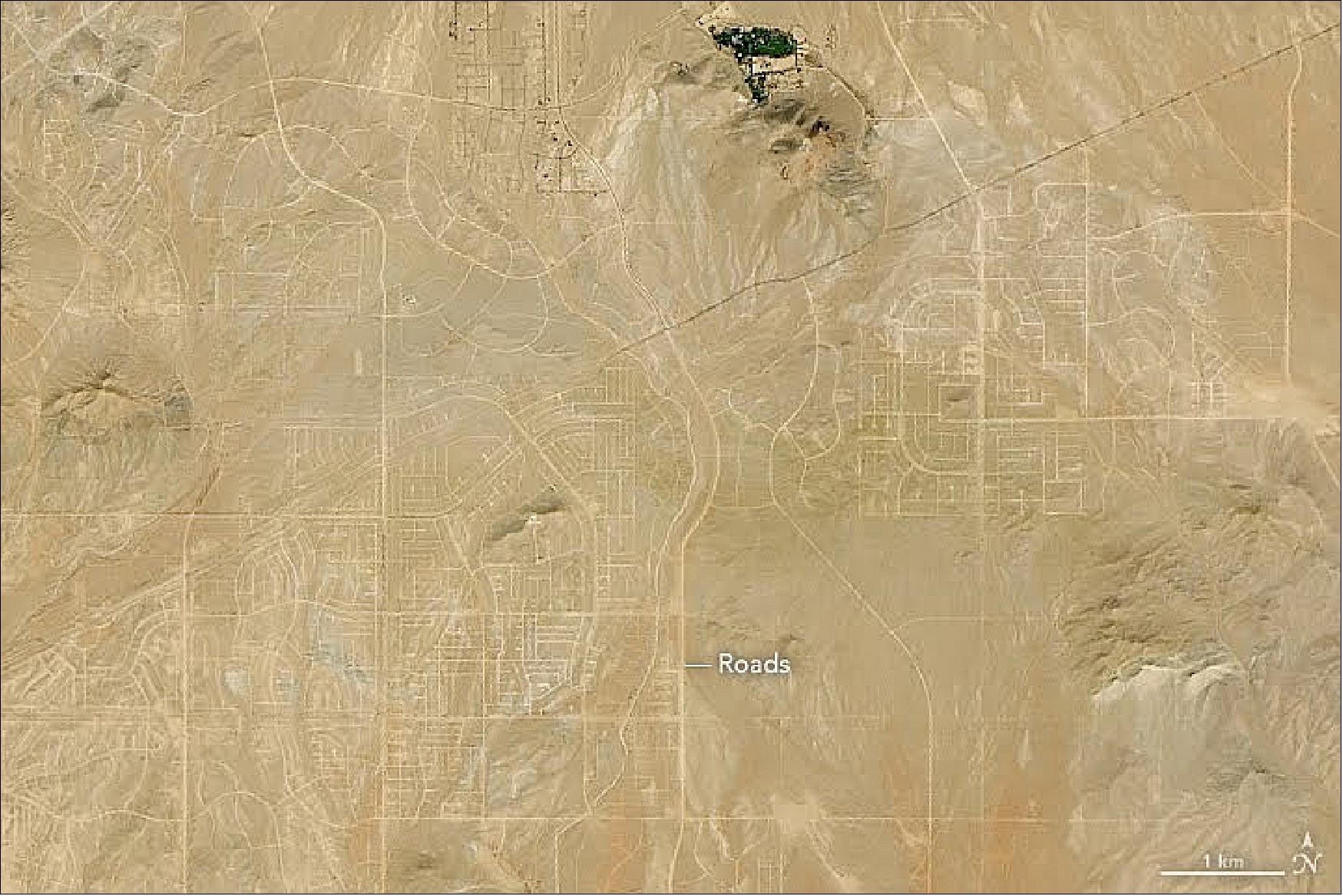 Figure 52: Though a large network of perfectly gridded blocks and curving residential streets remain etched into the Mojave Desert, houses are scarce (image credit: NASA Earth Observatory, image by Lauren Dauphin, using Landsat data from the U.S. Geological Survey. Story by Adam Voiland)