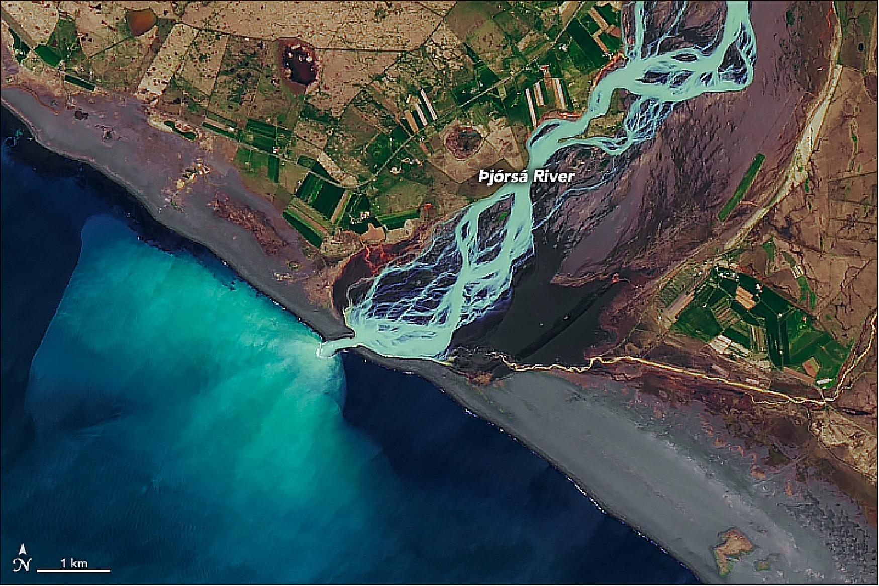 Figure 50: The Þjórsá River is both Iceland’s longest (230 km) and its second-largest by volume, moving an average of 370 m3/s of water. In this view, we see the river where it meets the Atlantic Ocean at the island’s south side. Before entering the ocean the river becomes braided, as channels of water flow around small, temporary islands of coarse sediment. The dark areas near the river’s mouth are wet volcanic sand. Where the water enters the ocean, the stark contrast in color is again due to two water types that do not mix well: in this case, glacial water and seawater of differing temperatures and densities (image credit: NASA Earth Observatory, image by Joshua Stevens, using Landsat data from the U.S. Geological Survey. Story by Kathryn Hansen with image interpretation by Emmanuel Pagneux, University of Iceland)