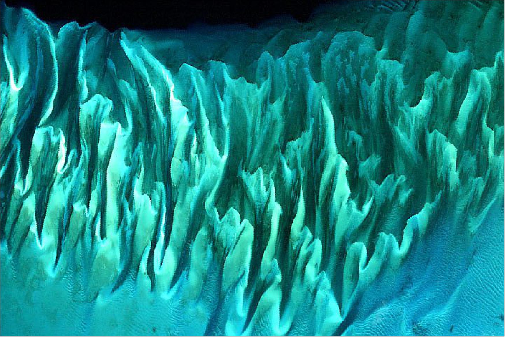 Figure 85: Andréfouet’s image shows a small section of the Great Bahama Bank as it appeared on 17 January 2001, and was acquired by the Enhanced Thematic Mapper Plus (ETM+) on the Landsat-7 satellite (using bands 1-2-3). At that time the instrument’s blue channel (band 1) helped distinguish shallow water features better than previous satellite mission (image credit: NASA Earth Observatory, images by Joshua Stevens, using Landsat data from the U.S. Geological Survey, and GIBS/Worldview.2002 imagery courtesy Serge Andrefouet, University of South Florida. Story by Kasha Patel)