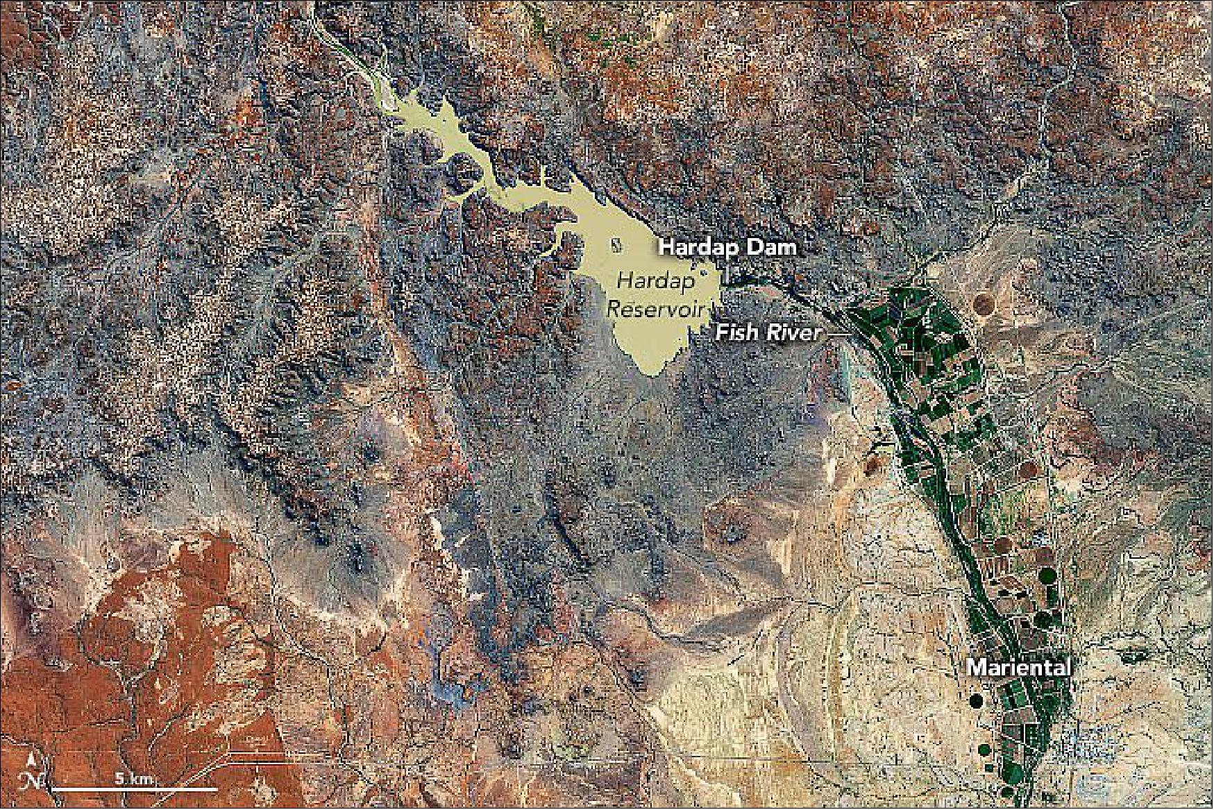 Figure 71: Originally founded as a railway stop in 1912, Mariental lies in between the two zones in a hot, arid region that receives little precipitation. Its main economic activities are game farming rather than traditional farming. Specifically, Mariental is a hub for farming sheep and processing sheep skins. It is also known for farming ostrich, which can survive well under the arid conditions (image credit: NASA Earth Observatory)
