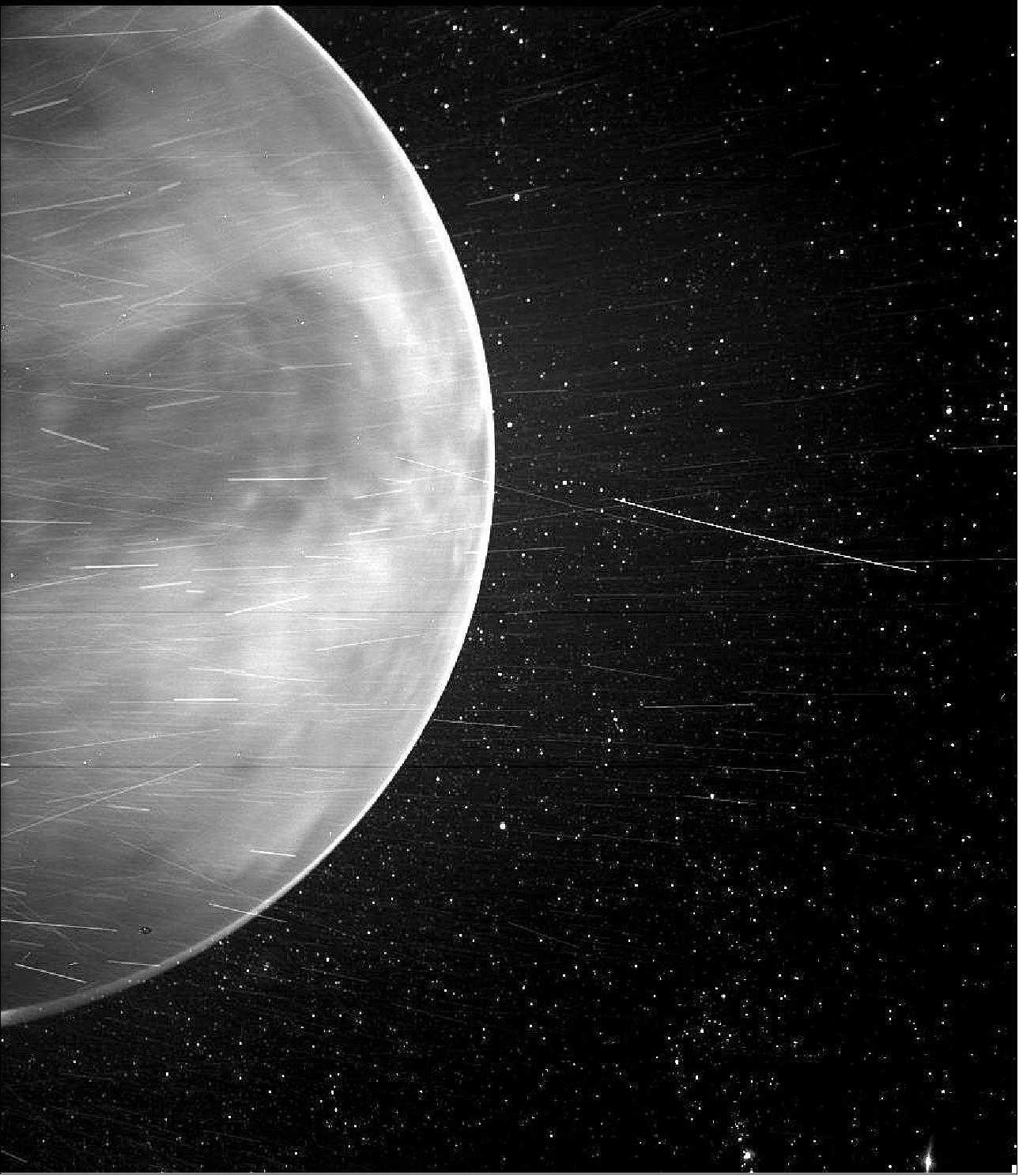 Figure 50: When flying past Venus in July 2020, Parker Solar Probe's WISPR (Wide-field Imager for Parker Solar Probe) instrument detected a bright rim around the edge of the planet that may be nightglow — light emitted by oxygen atoms high in the atmosphere that recombine into molecules in the nightside. The prominent dark feature in the center of the image is Aphrodite Terra, the largest highland region on the Venusian surface. Bright streaks in WISPR, such as the ones seen here, are typically caused by a combination of charged particles — called cosmic rays — sunlight reflected by grains of space dust, and particles of material expelled from the spacecraft's structures after impact with those dust grains. The number of streaks varies along the orbit or when the spacecraft is traveling at different speeds, and scientists are still in discussion about the specific origins of the streaks here. The dark spot appearing on the lower portion of Venus is an artifact from the WISPR instrument (image credits: NASA/Johns Hopkins APL/Naval Research Laboratory/Guillermo Stenborg and Brendan Gallagher)