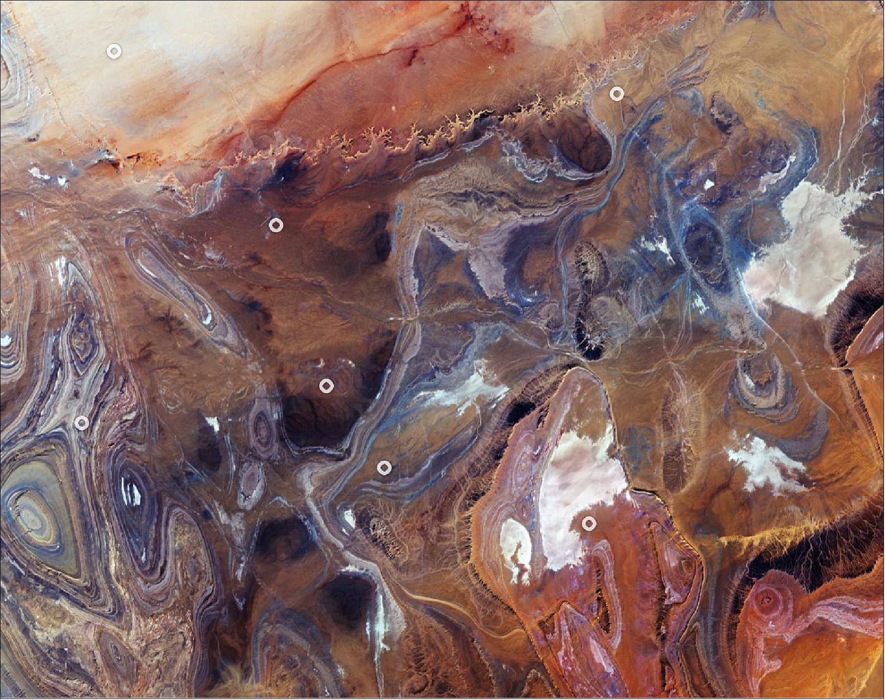 Figure 78: Tanezrouft is a region of the Sahara lying in southern Algeria and northern Mali. The hyperarid area is known for its soaring temperatures and scarce access to water and vegetation, a reason why it’s often referred to as the ‘Land of Terror’. There are no permanent residents that live here, only occasional Tuareg nomads. This image, also featured on the Earth from Space video program, was captured on 12 January 2020 by the Copernicus Sentinel-2 mission (image credit: ESA, the image contains modified Copernicus Sentinel data (2020), processed by ESA, CC BY-SA 3.0 IGO)