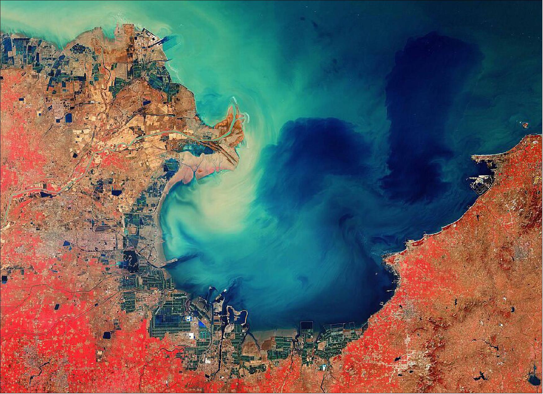 Figure 54: This Sentinel-2 image, acquired on 26 February 2020, is also featured on the Earth from Space video program. This image was processed in a way that included the near-infrared channel, which makes vegetation appear bright red. The lush vegetation can be distinguished from the brown fields in the image, which are unharvested or not yet fully grown (image credit: ESA, the image contains modified Copernicus Sentinel data (2020), processed by ESA, CC BY-SA 3.0 IGO)