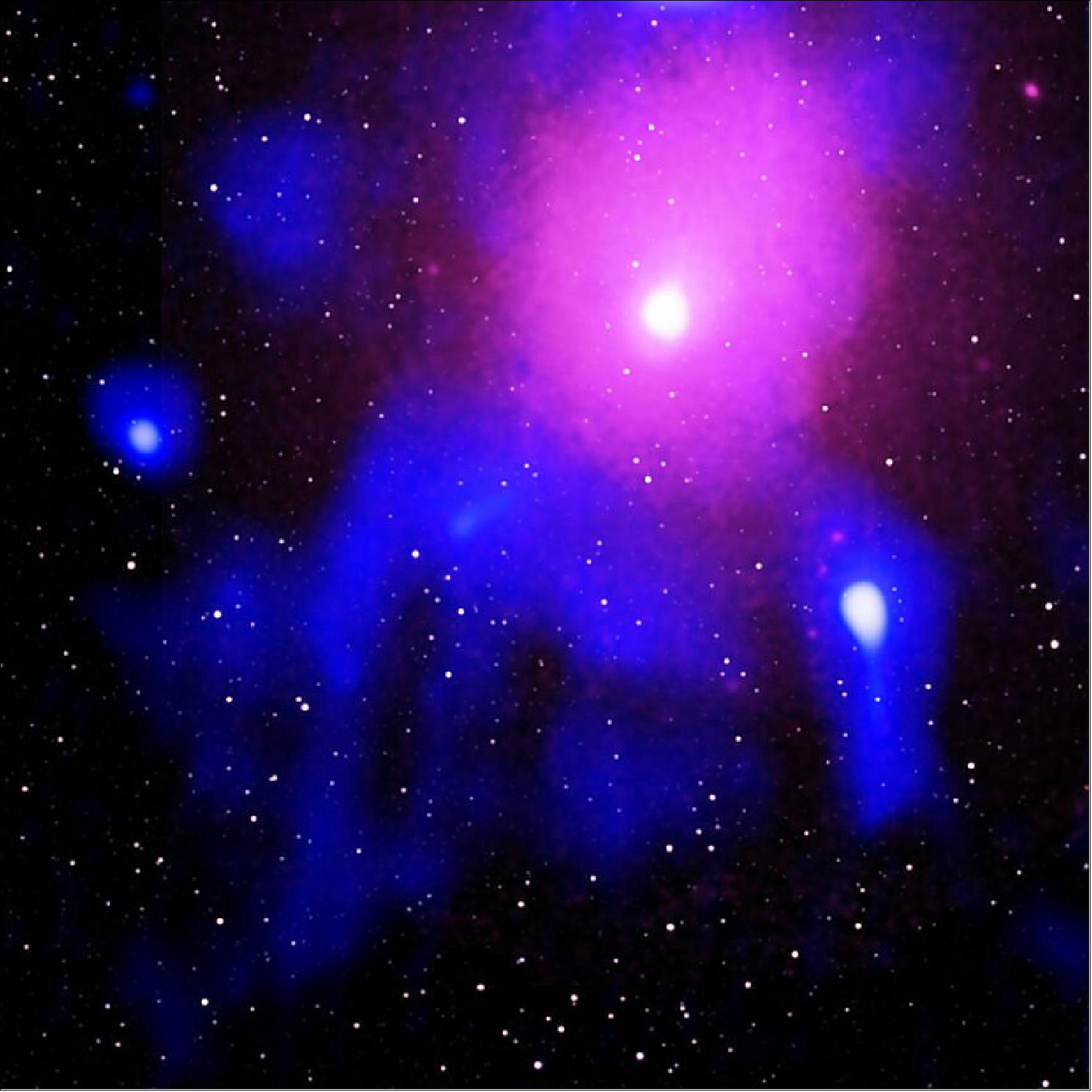 Figure 39: In this image, the diffuse hot gas pervading the cluster is revealed through X-ray observations from XMM-Newton (shown in pink), radio data from the Giant Meterwave Radio Telescope (shown in blue), and infrared data from the 2MASS survey (shown in white). Bright dots sprinkled across the image reflect the distribution of foreground stars and galaxies; in this complementary image, the inset in the lower right shows a zoomed-in X-ray view based on Chandra data (also shown in pink) [image credit: X-ray: ESA/XMM-Newton and NASA/CXC/Naval Research Lab/S. Giacintucci; Radio: NCRA/TIFR/GMRTN; Infrared: 2MASS/UMass/IPAC-Caltech/NASA/NSF]