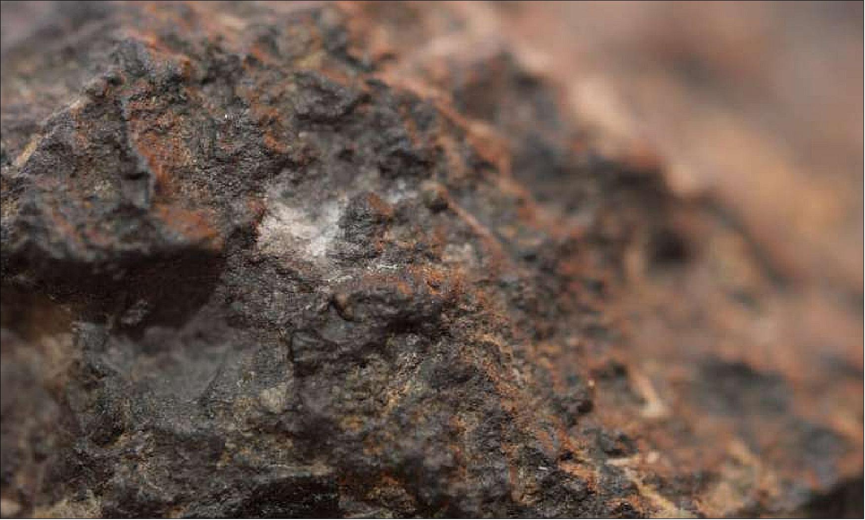 Figure 92: The white inclusions called CAIs are among the oldest solid matter in the solar system (image credit: Rohan Mehra, Division for Strategic Public Relations)