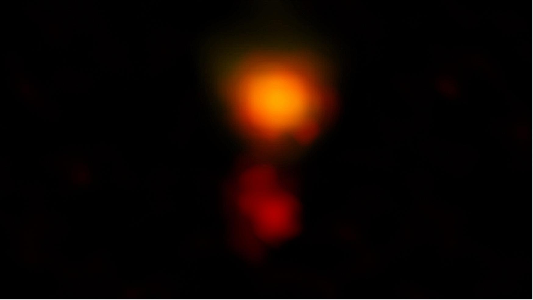 Figure 78: ALMA radio image of the dusty star-forming galaxy called MAMBO-9. The galaxy consists of two parts, and it is in the process of merging (image credit: ALMA (ESO/NAOJ/NRAO), C. M. Casey et al.; NRAO/AUI/NSF, B. Saxton)