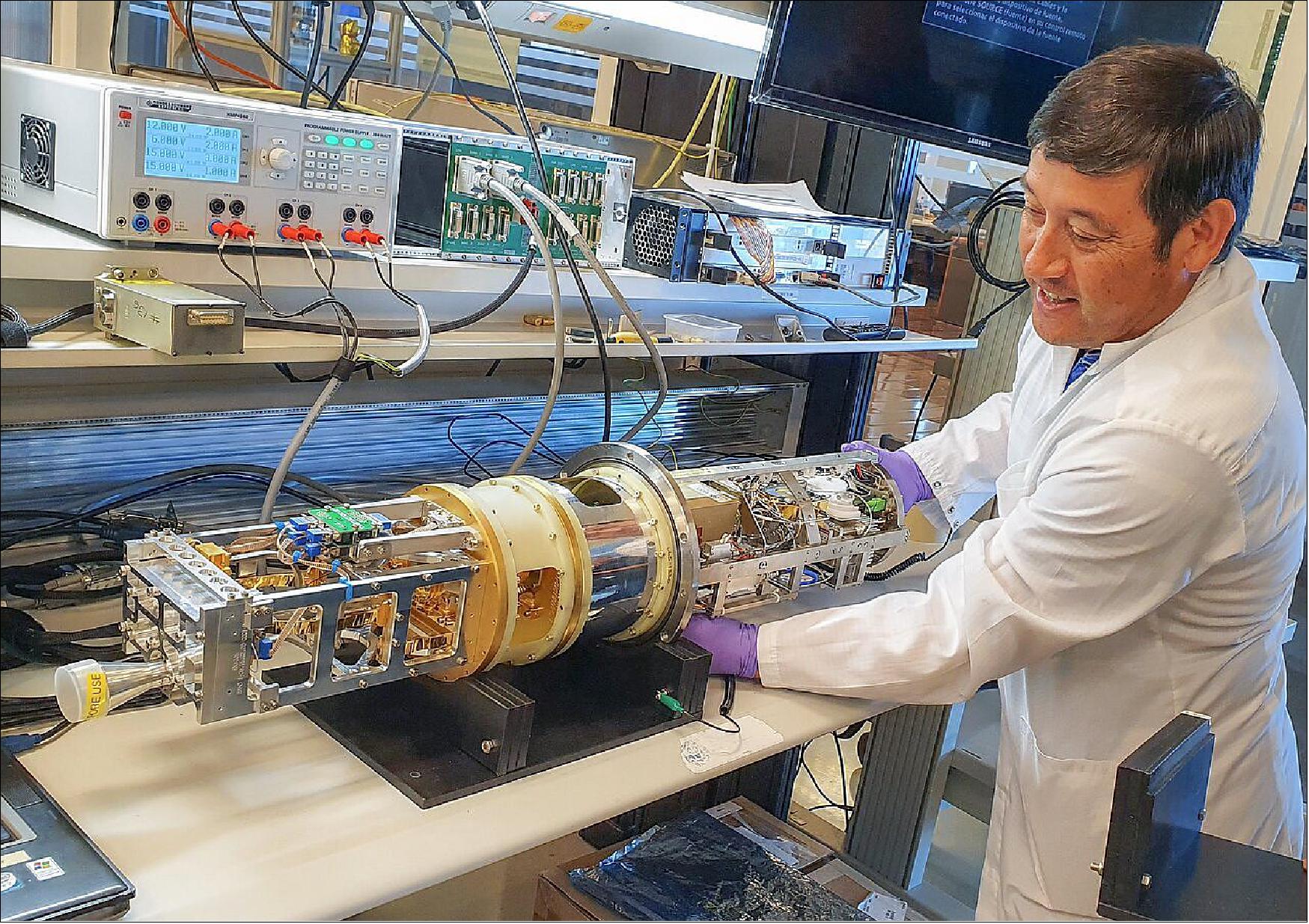 Figure 32: Assembly of ALMA band 1 cartridges. Electronics Technician Nelson Tabilo assembles one of the cold and warm cartridges which form part of the band 1 receivers installed on ALMA. The band 1 receivers pick up radio waves between 6 and 8.5 mm in length, the longest wavelength that ALMA is able to measure [image credit: G. Siringo, ALMA (ESO/NAOJ/NRAO)]