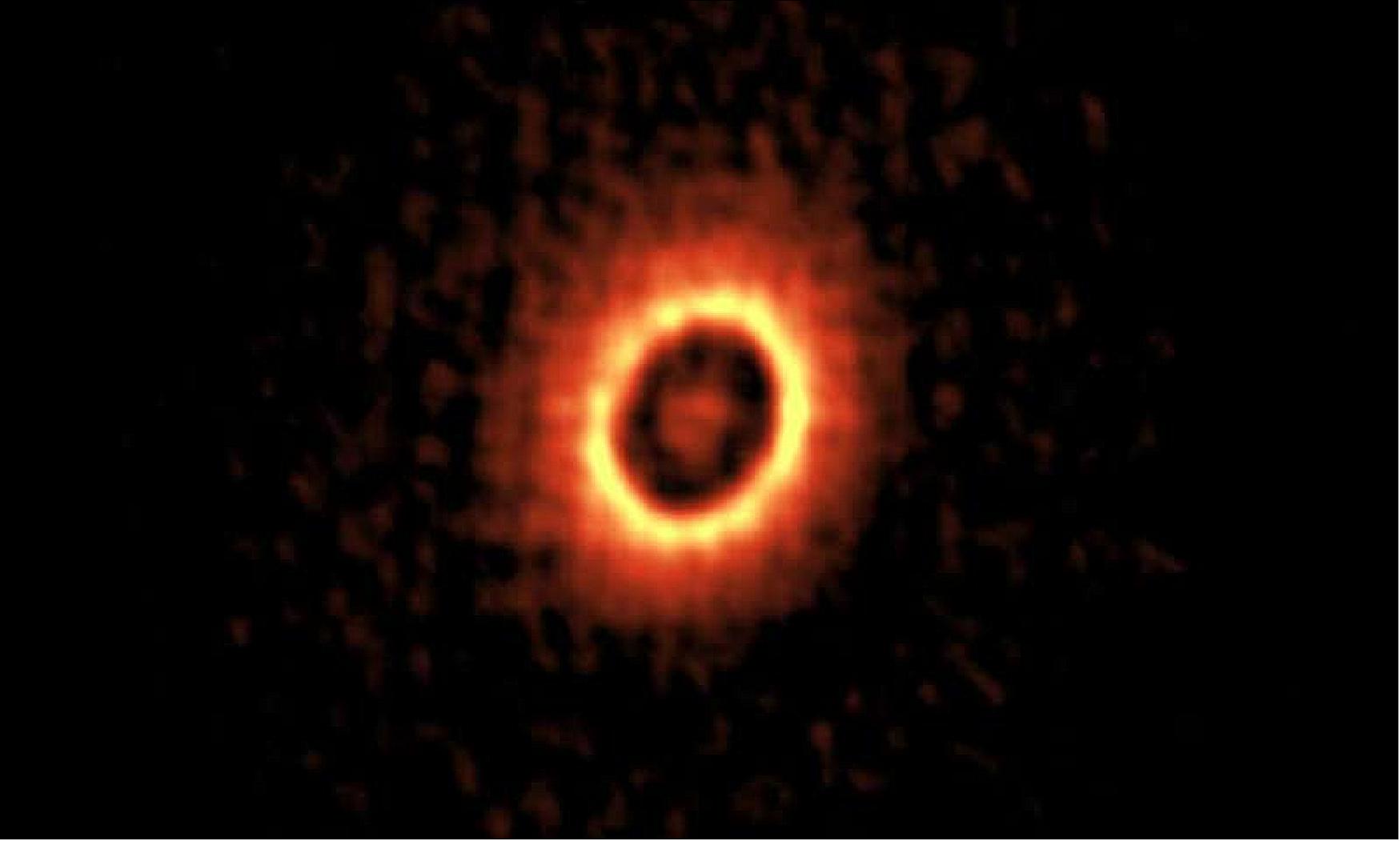 Figure 98: ALMA image of the dusty disk around the young star DM Tau. You can see two concentric rings where planets may be forming (image credit: ALMA (ESO/NAOJ/NRAO), Kudo et al.)