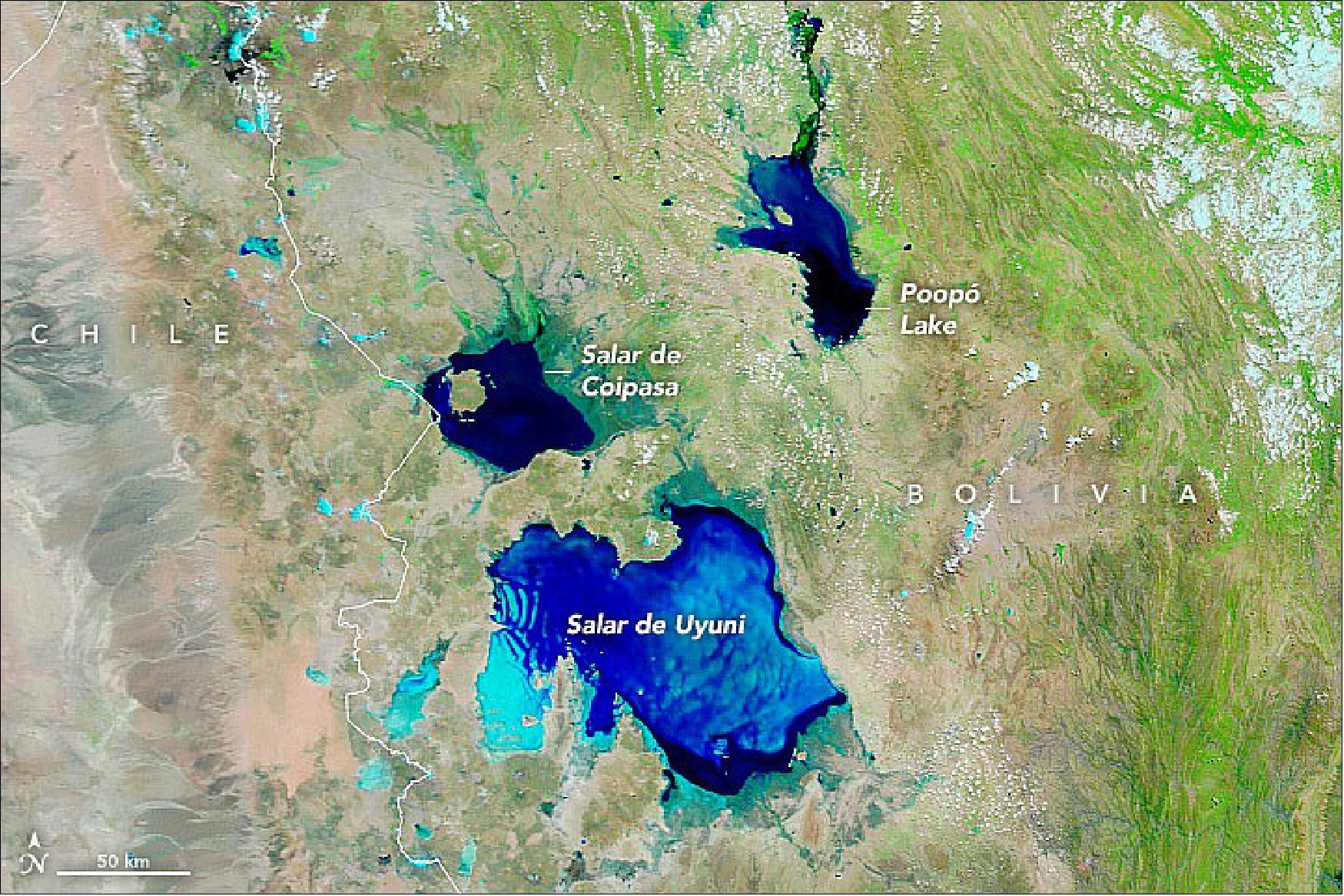 Figure 36: This false-color image was acquired with MODIS on NASA's Terra satellite on February 19, 2022.The image is composed from a combination of visible light, near-infrared, and shortwave infrared (MODIS bands 7-2-1) to better distinguish standing water (blue and dark blue) from clouds (white) and the salt flats (shades of teal), image credit: NASA Earth Observatory