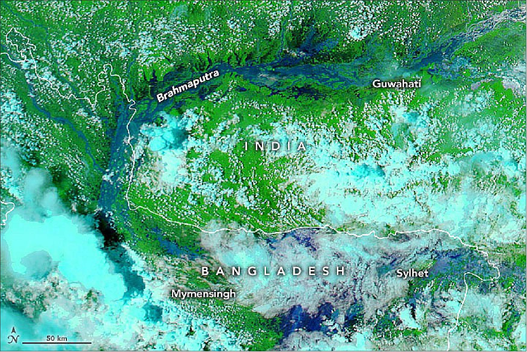 Figure 6: This image shows northeast Bangladesh and India on 22 June 2022. The false-color image, acquired with the MODIS instrument on NASA’s Aqua satellite, combine infrared and visible light (bands 7-2-1) to make it easier to see the boundary between water and land. Water appears navy blue and black; clouds are white or cyan; and vegetation is bright green. Monsoon rains have overwhelmed villages, inundated crops, and displaced hundreds of thousands of people (image credit: NASA Earth Observatory images by Joshua Stevens, using MODIS data from NASA EOSDIS LANCE and GIBS/Worldview. Story by Adam Voiland)