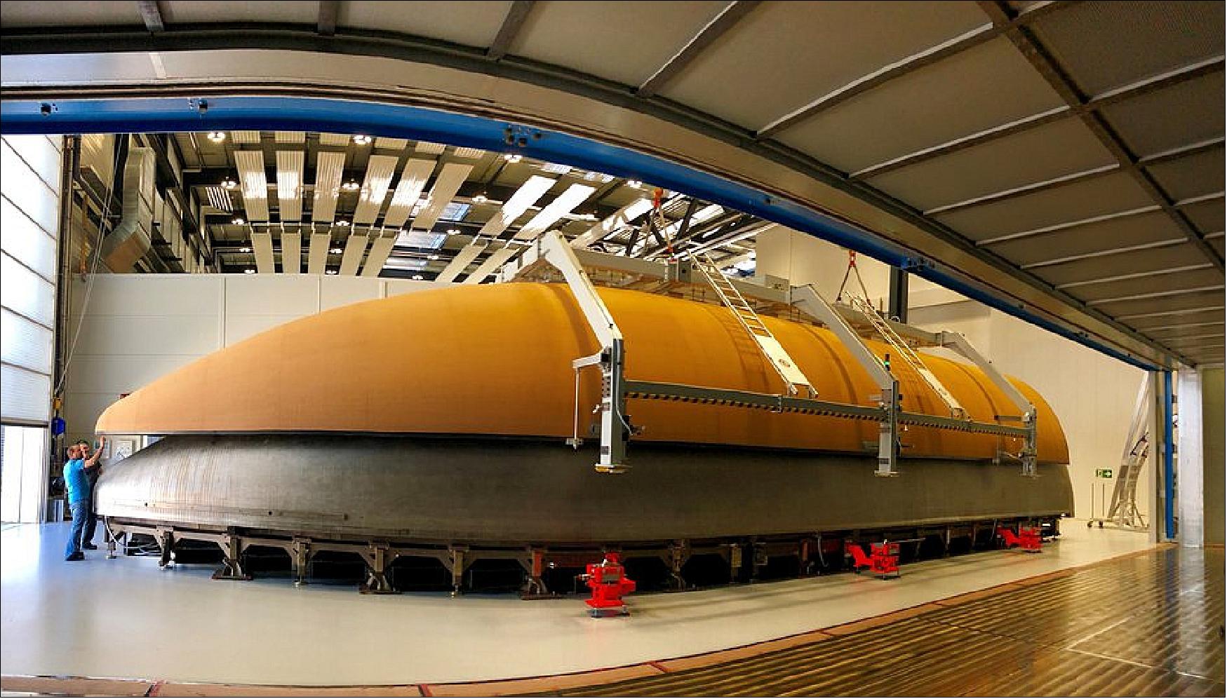 Figure 72: With the help of ESA, RUAG Space developed an out-of-autoclave process where the carbon-fibre shells of the rocket fairing are cured in an industrial oven instead of an autoclave. It reduces cost and saves time. - The first fairing manufactured in this way was flown on Ariane 5, flight VA238 on 28 June 2017. Vega began using the new type of fairing on 1 August 2017. Ariane 6 and Vega-C fairings will also be produced in the same way. The first half-shell of Ariane 6 (pictured) has been made [image credit: RUAG Space (Switzerland)] 57)