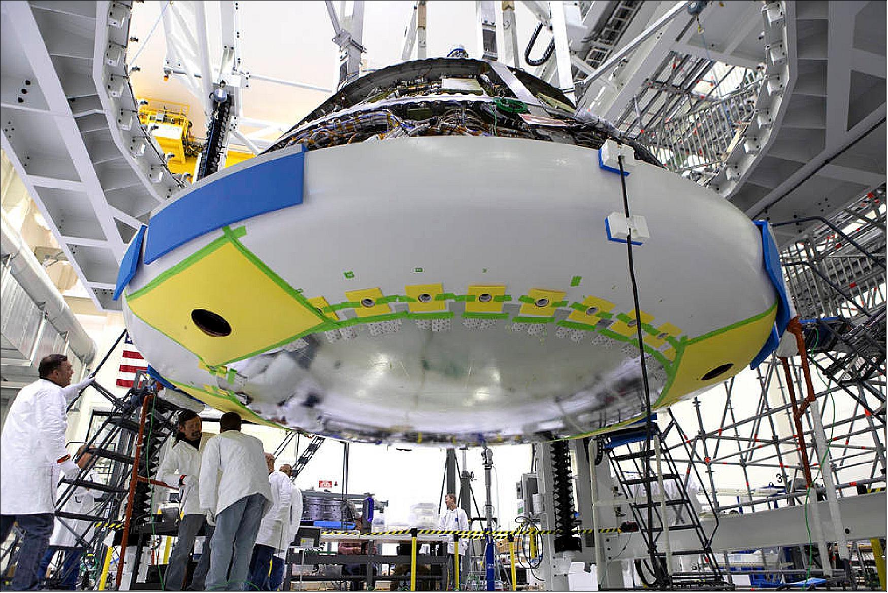 Figure 62: Lockheed Martin engineers and technicians check fittings during installation of the heat shield to the Orion crew module July 25, 2018, inside the Neil Armstrong Operations and Checkout Building high bay at NASA's Kennedy Space Center in Florida (image credit: NASA)