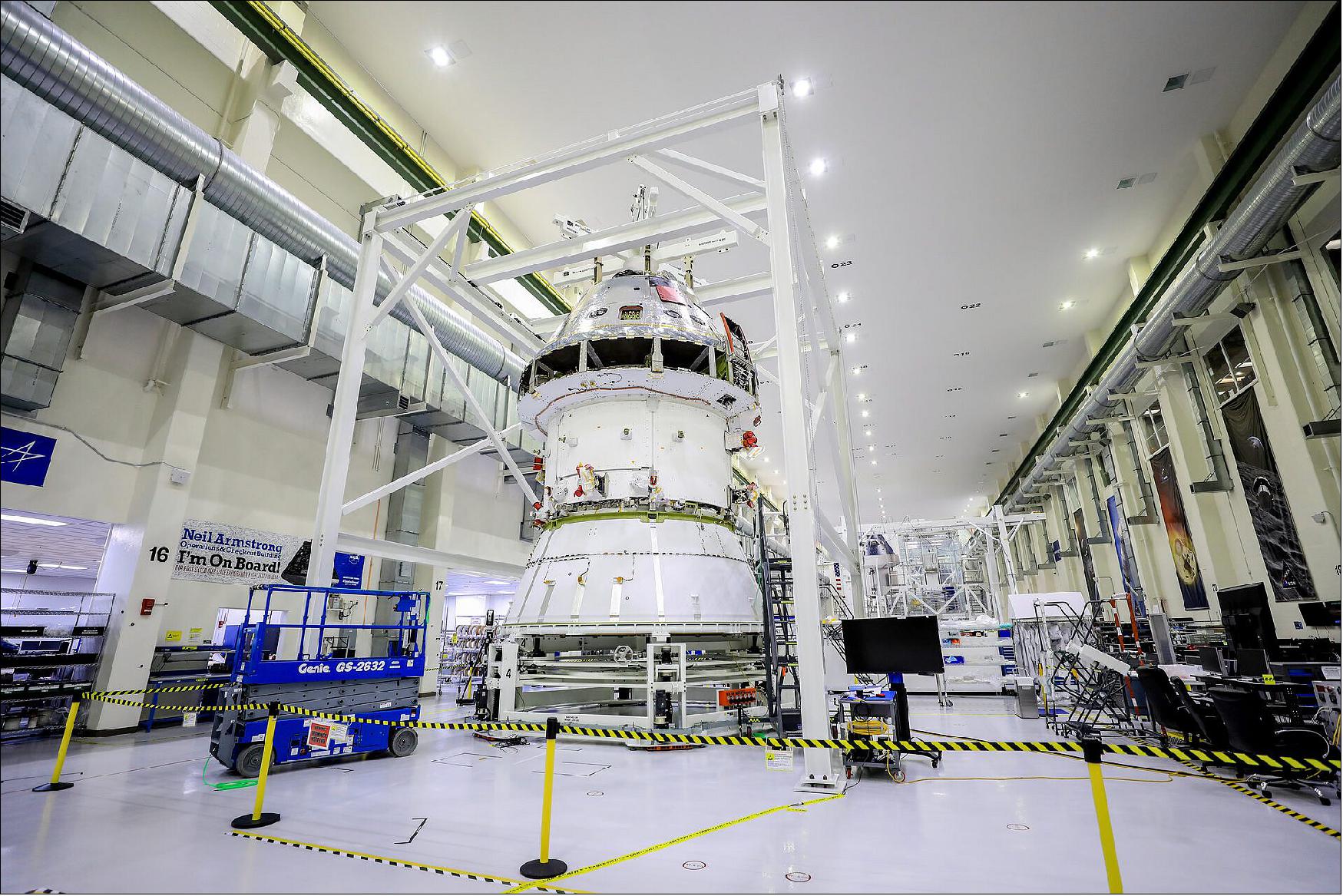 Figure 38: The spacecraft adapter cone (seen at the bottom of the stack pictured above) connects to the bottom of Orion’s service module and will later join another adapter connected to the top of the rocket’s interim cryogenic propulsion stage (ICPS). During the process to install the cone on Orion, the spacecraft is lifted out of the FAST (Final Assembly and Systems Testing) cell and placed into the Super Station support fixture (image credit: NASA, Brian Dunbar, ESA)