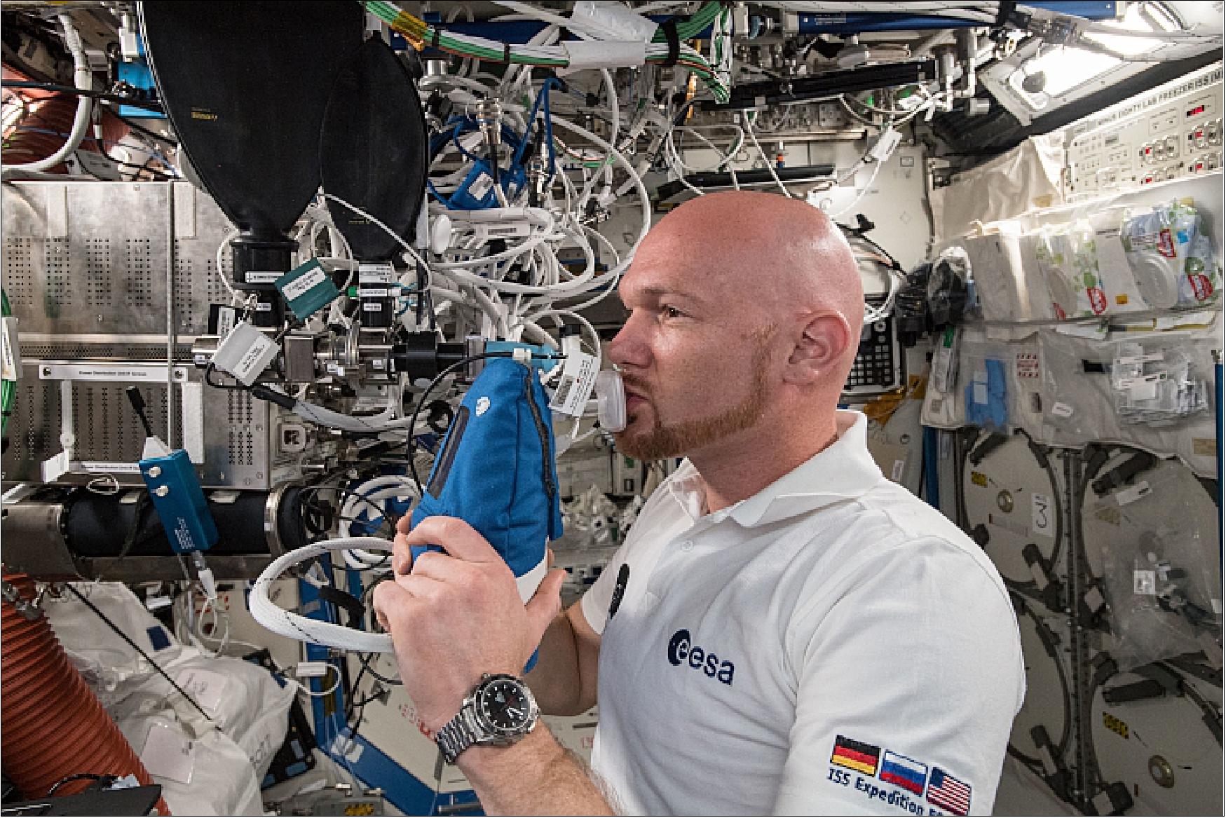 Figure 49: ESA (European Space Agency) astronaut Alexander Gerst exhales into an ultra-sensitive gas analyzer for the Airway Monitoring experiment, a study of airway inflammation in crew members. Results help flight surgeons plan safer long-term missions to the Moon and Mars and may help patients on Earth with asthma or other airway inflammatory diseases (image credit: NASA)