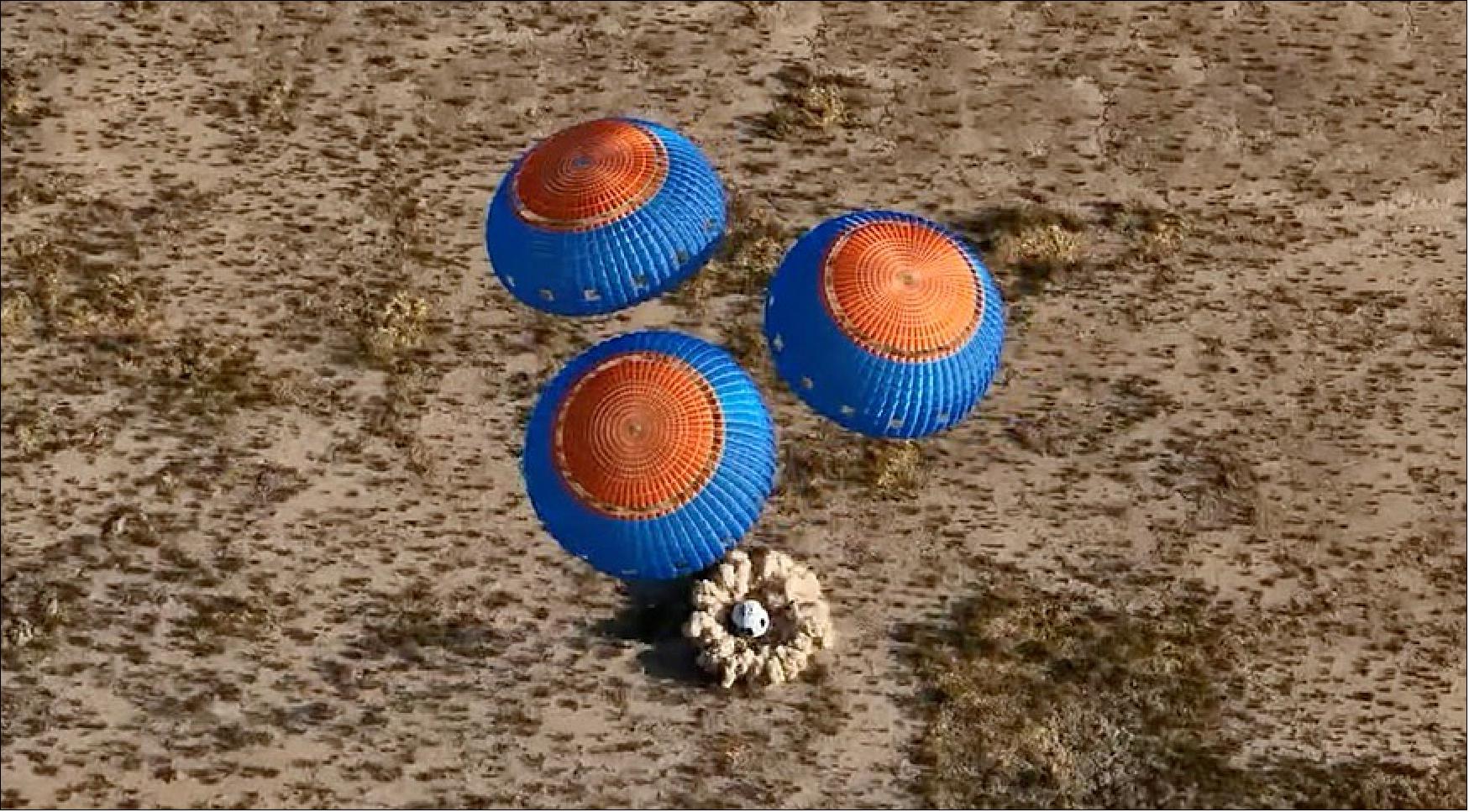 Figure 3: The New Shepard crew capsule touches down in the West Texas desert at the end of the NS-21 mission that launched June 4 (image credit: Blue Origin webcast)