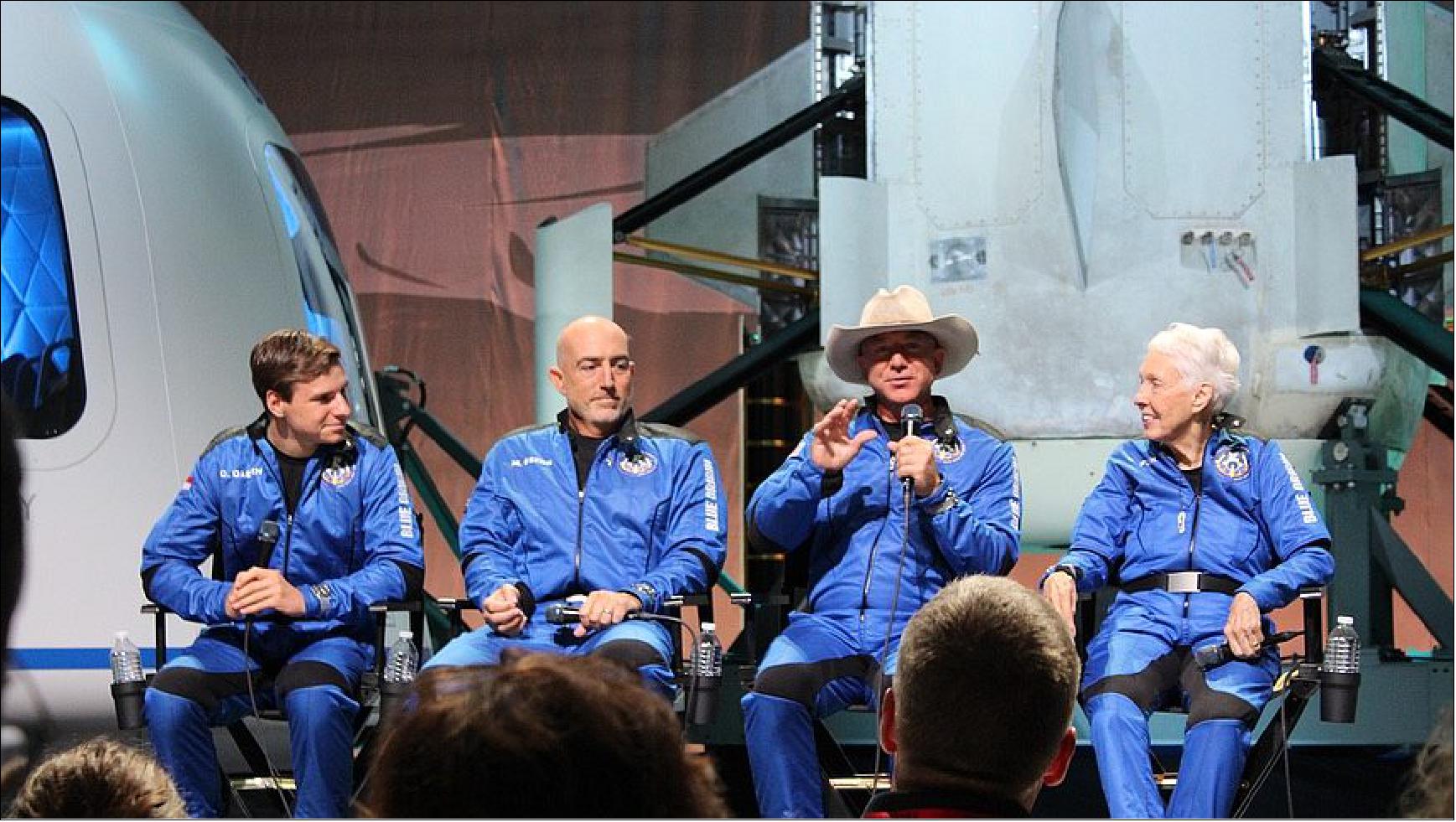 Figure 18: Jeff Bezos (third from left) speaks at a post-flight ceremony with the other people who flew on the NS-16 mission (from left): Oliver Daemen, Mark Bezos and Wally Funk (image credit: SpaceNews/Jeff Foust)