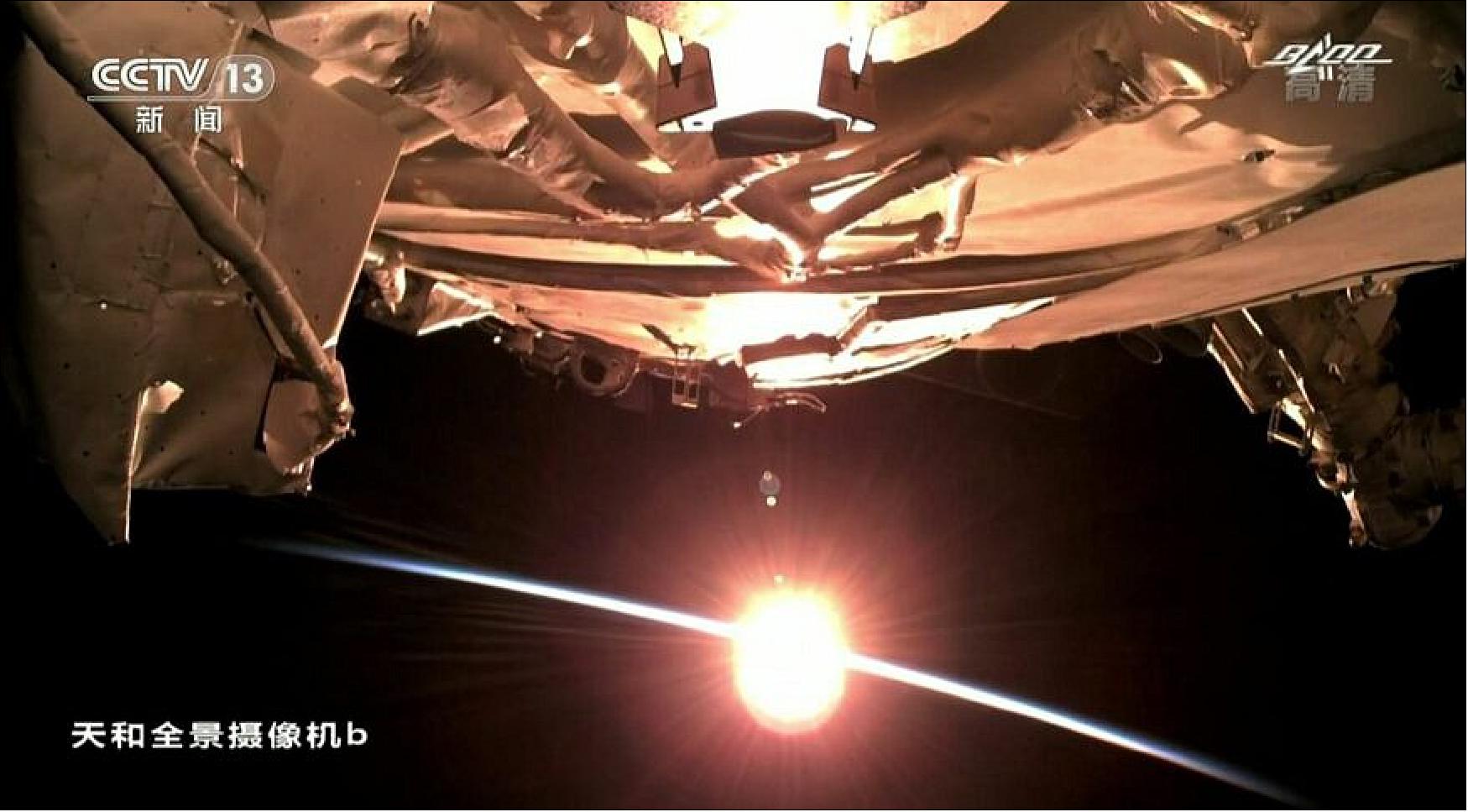 Figure 23: A view of the Sun on the horizon from Tianhe ahead of the Shenzhou-12 docking (image credit: BACC/CCTV/screenshot)