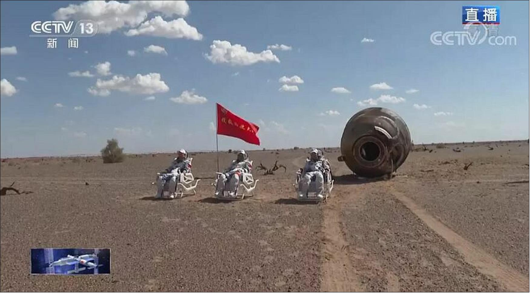 Figure 43: The three Shenzhou-12 astronauts outside of the return module after landing in Dongfeng, 17 September 2021 (image credit: CCTV/framegrab)