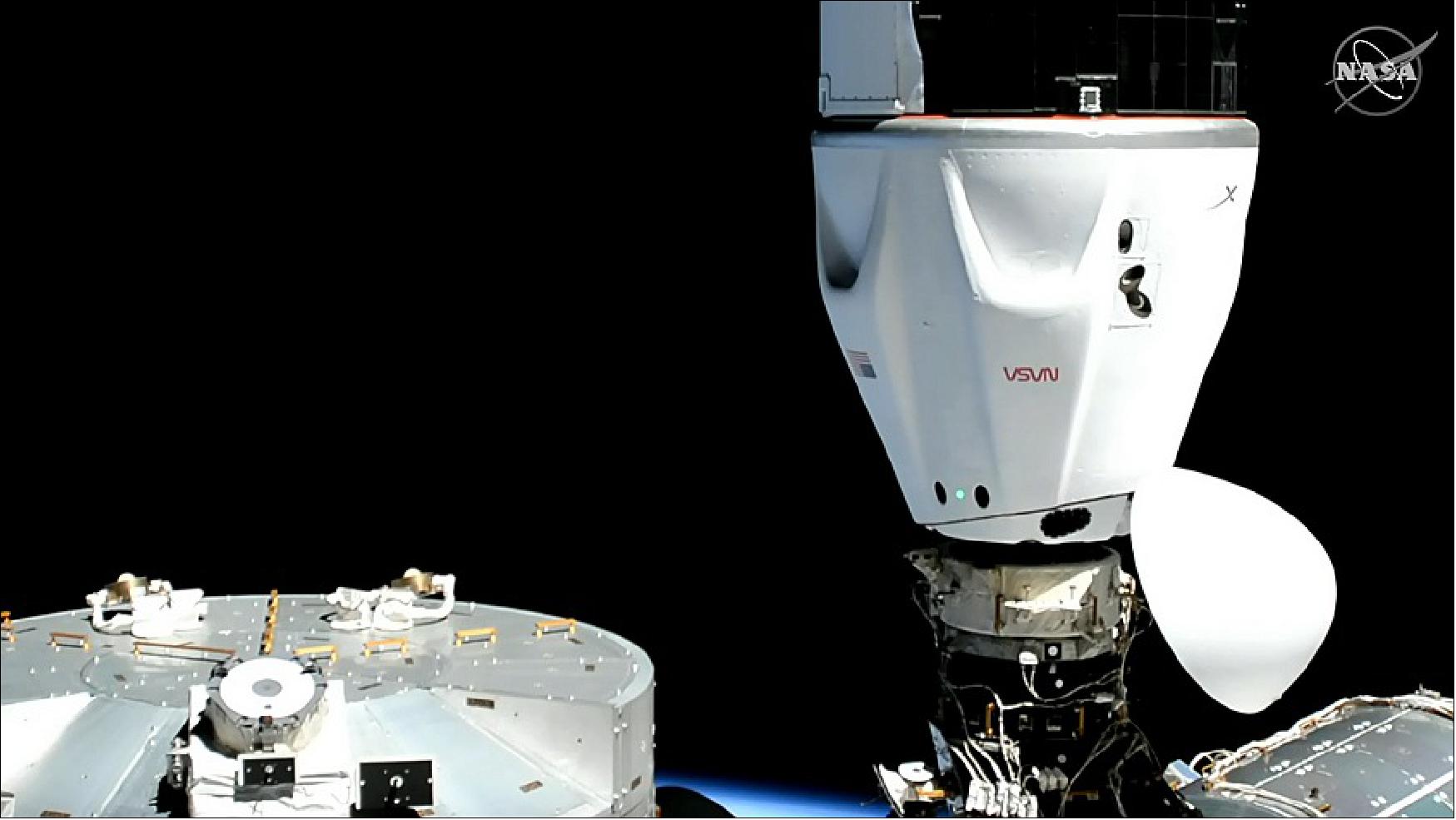 Figure 25: The SpaceX Dragon Freedom capsule is seen after docking to the International Space Station while the station was orbiting 261 statute miles above the Pacific Ocean (image credit: NASA TV)