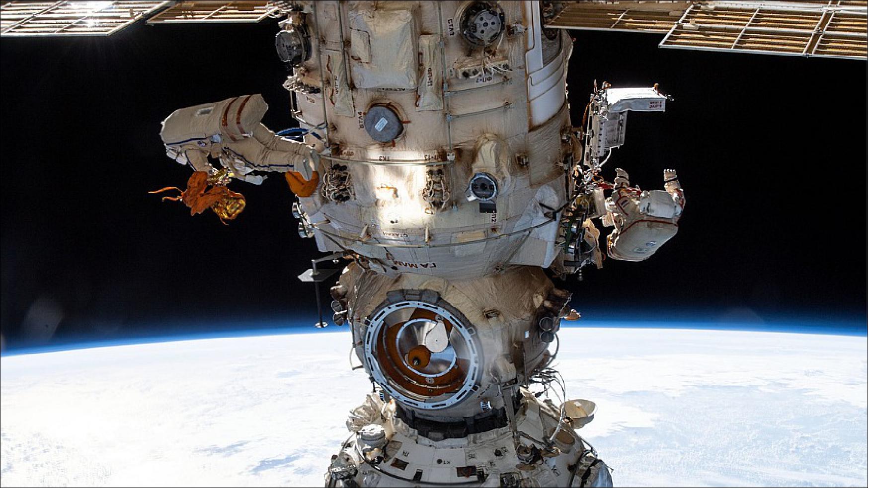 Figure 22: Cosmonauts (from left) Denis Matveev and Oleg Artemyev worked outside the station’s Russian segment during the first spacewalk to outfit Nauka and configure the European robotic arm on April 18, 2022 (image credit: NASA TV)