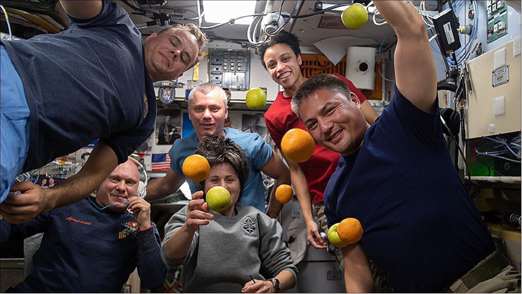 Figure 13: Expedition 67 crew members pose with fresh fruit delivered aboard the Progress 81 cargo craft on June 3, 2022 (image credit: NASA TV)
