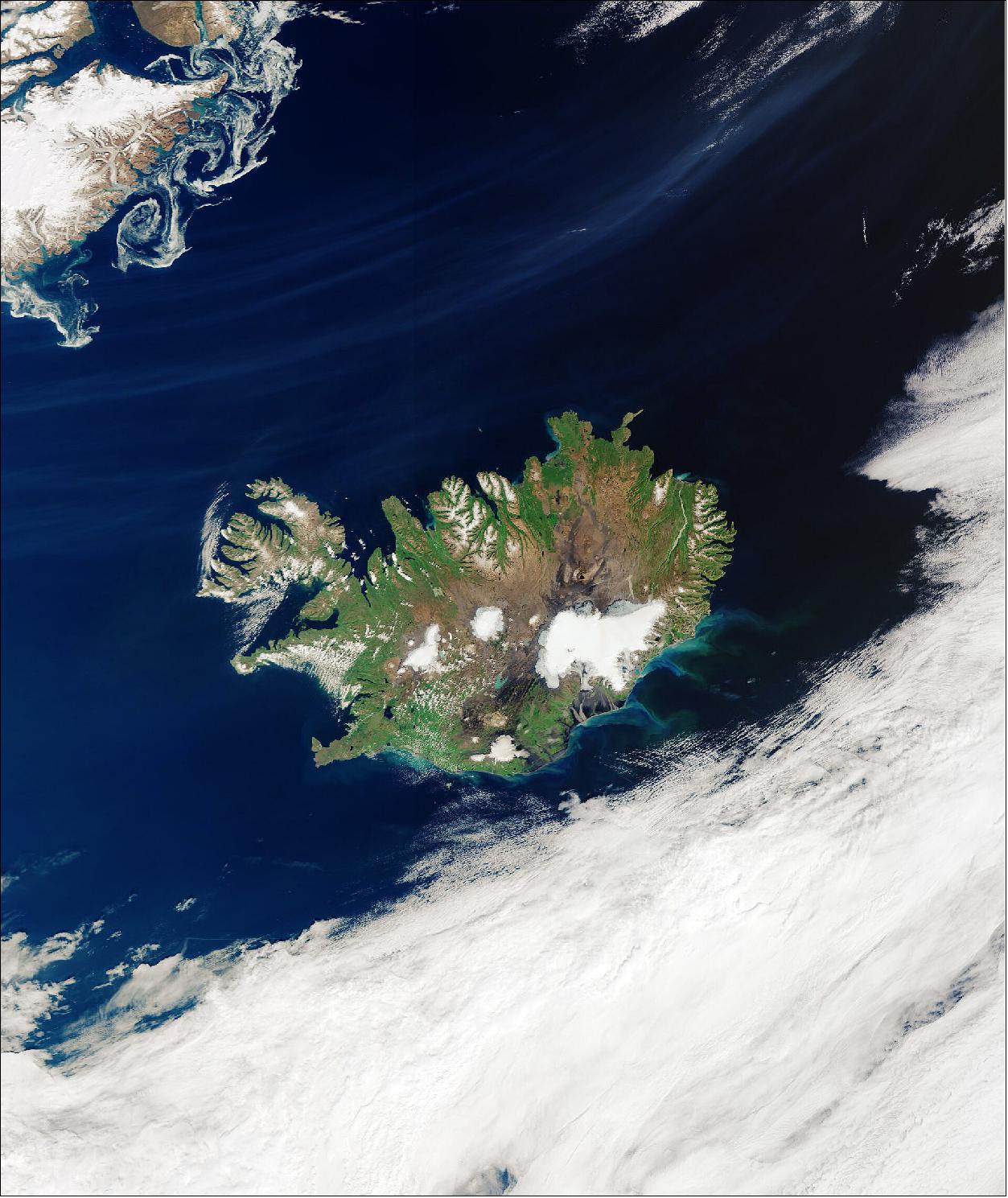 Figure 48: Cloud-free Iceland. The large, white area visible on the island is a national park that encompasses the Vatnajökull Glacier. Covering an area of around 8400 km2 with an average ice thickness of more than 900 m, Vatnajökull is not only classified as the biggest glacier in Iceland, but the biggest in Europe. The white, circular patch in the center of the country is Hofsjökull, the country’s third largest glacier and its largest active volcano. The elongated white area west of Hofsjökull is Langjökull, Iceland’s second largest ice cap. Reykjavík, the capital and largest city of Iceland, is located on the Seltjarnarnes Peninsula, in southwest Iceland. In the top-left of the image, several sea ice swirls can be seen off the coast of Greenland (image credit: ESA, the image contains modified Copernicus Sentinel data (2020), processed by ESA, CC BY-SA 3.0 IGO)