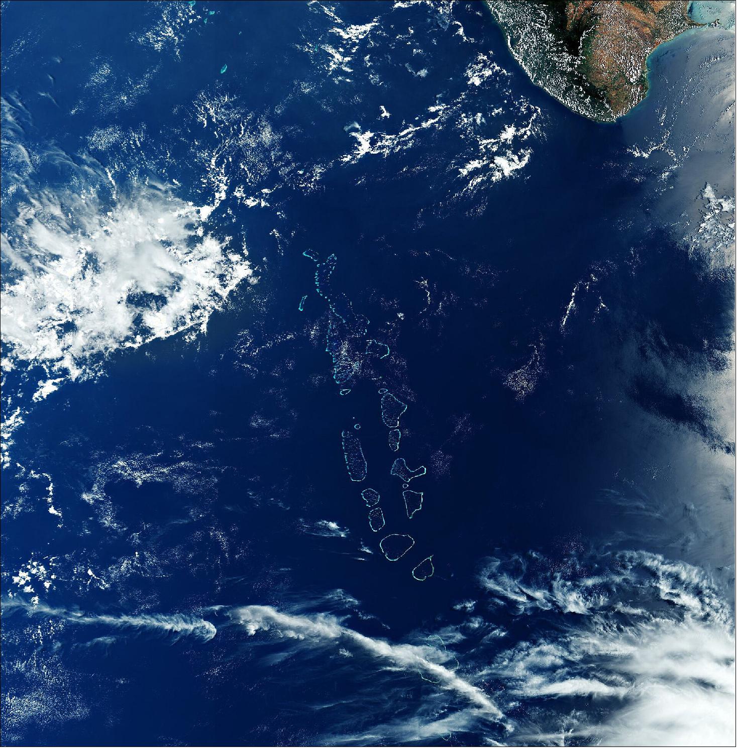 Figure 42: Most atolls of the Maldives consist of a large, ring-shaped coral reef supporting numerous small islands. In this image, captured on 29 March 2020, the Huvadhu Atoll and Addu Atoll are partially covered by clouds (visible in the bottom of the image). This image is also featured on the Earth from Space video program (image credit: ESA the image contains modified Copernicus Sentinel data (2020), processed by ESA, CC BY-SA 3.0 IGO)