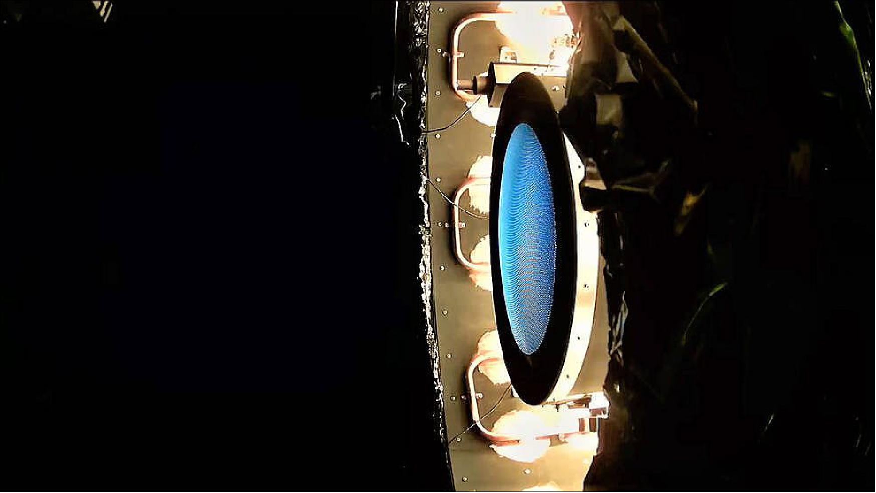 Figure 18: This image shows the NEXT-C flight thruster operating within the vacuum chamber during thermal vacuum testing (photo credit: NASA)