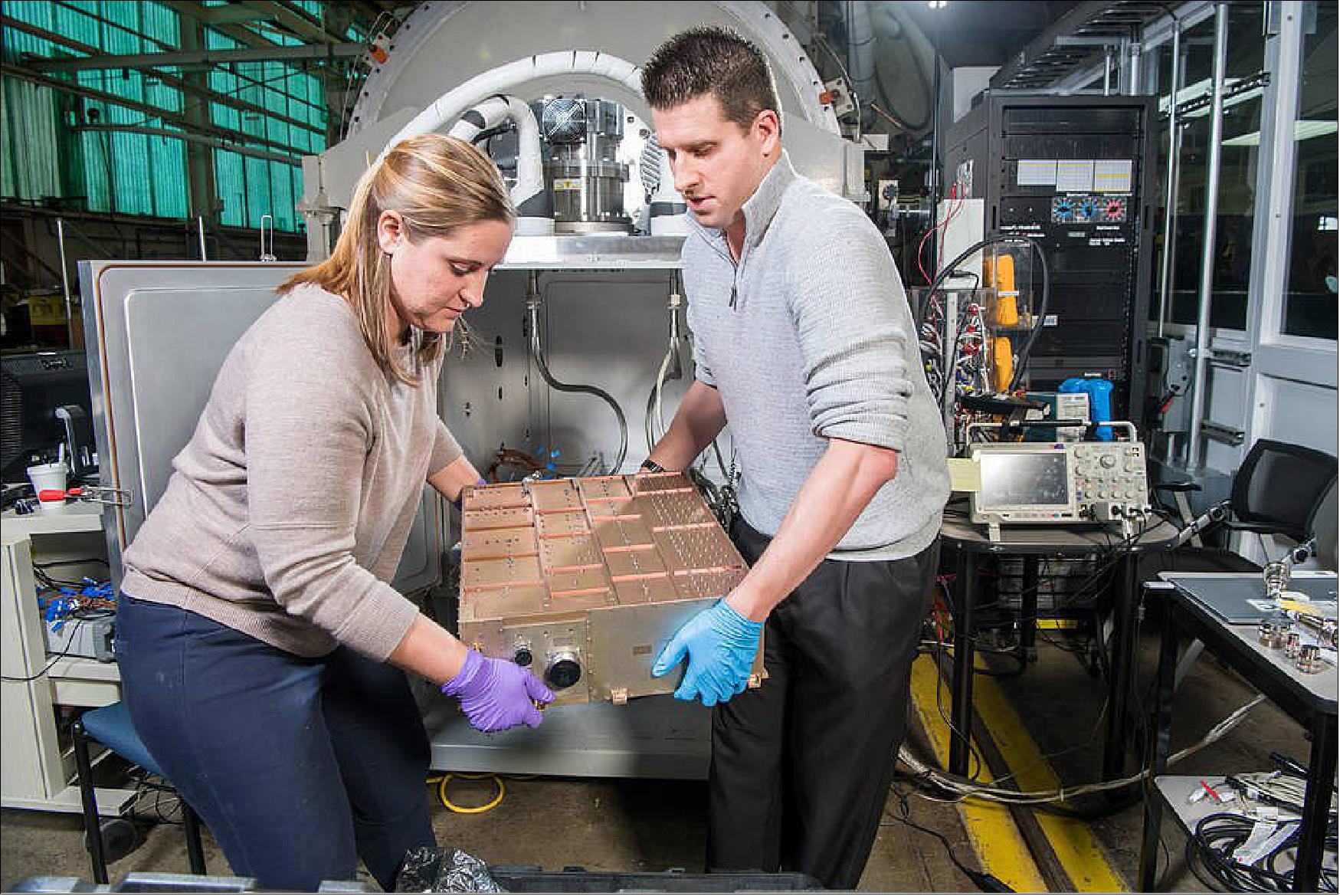 Figure 17: The power processing unit of the thruster is removed from another vacuum chamber after successful testing (image credit: NASA, Bridget Caswell)