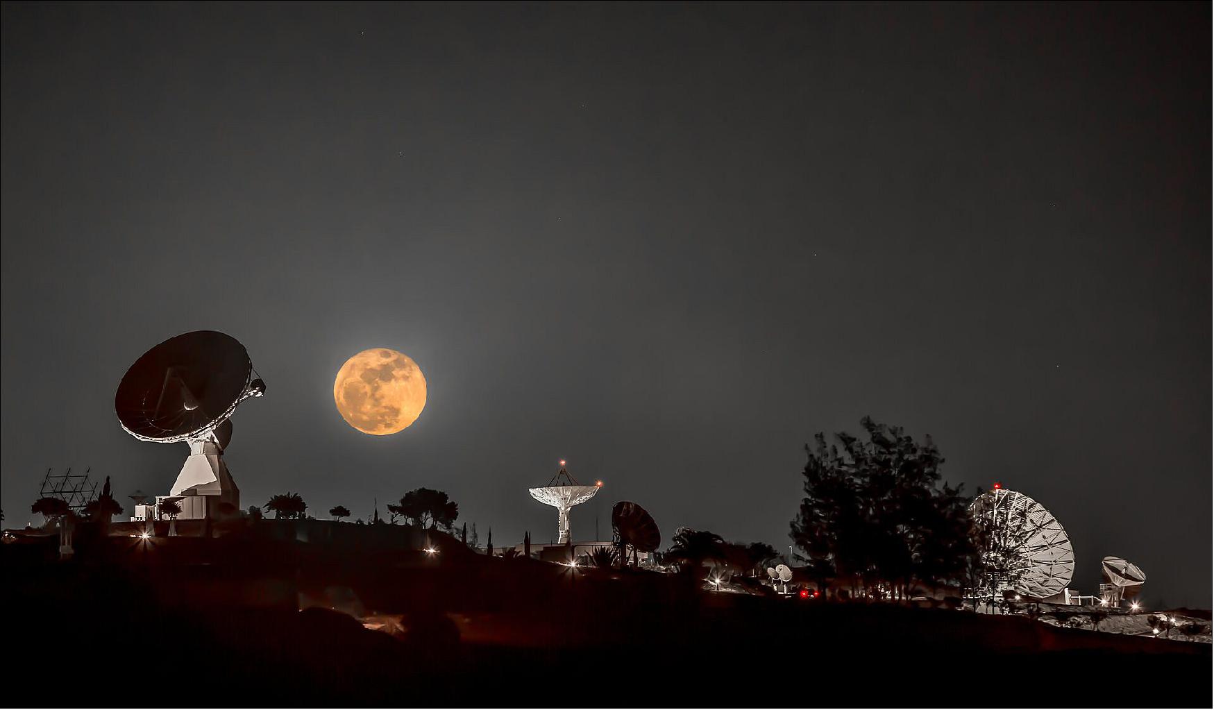 Figure 15: This gorgeous composite image shows this month’s full Moon, also known as a ‘Cold Moon’, seeming to hover above a set of satellite tracking dishes on the campus of the Instituto Nacional de Tecnica Aerospacial (INTA), in the southern part of the Canary Islands’ Gran Canaria, at Montaña Blanca. One of the antennas – the 15 m-diameter dish seen at left – is ESA’s Maspalomas tracking station, which currently communicates with ESA’s Cluster, LISA Pathfinder and XMM-Newton missions (image credit: Estrack Maspalomas station, Claus Vogl)
