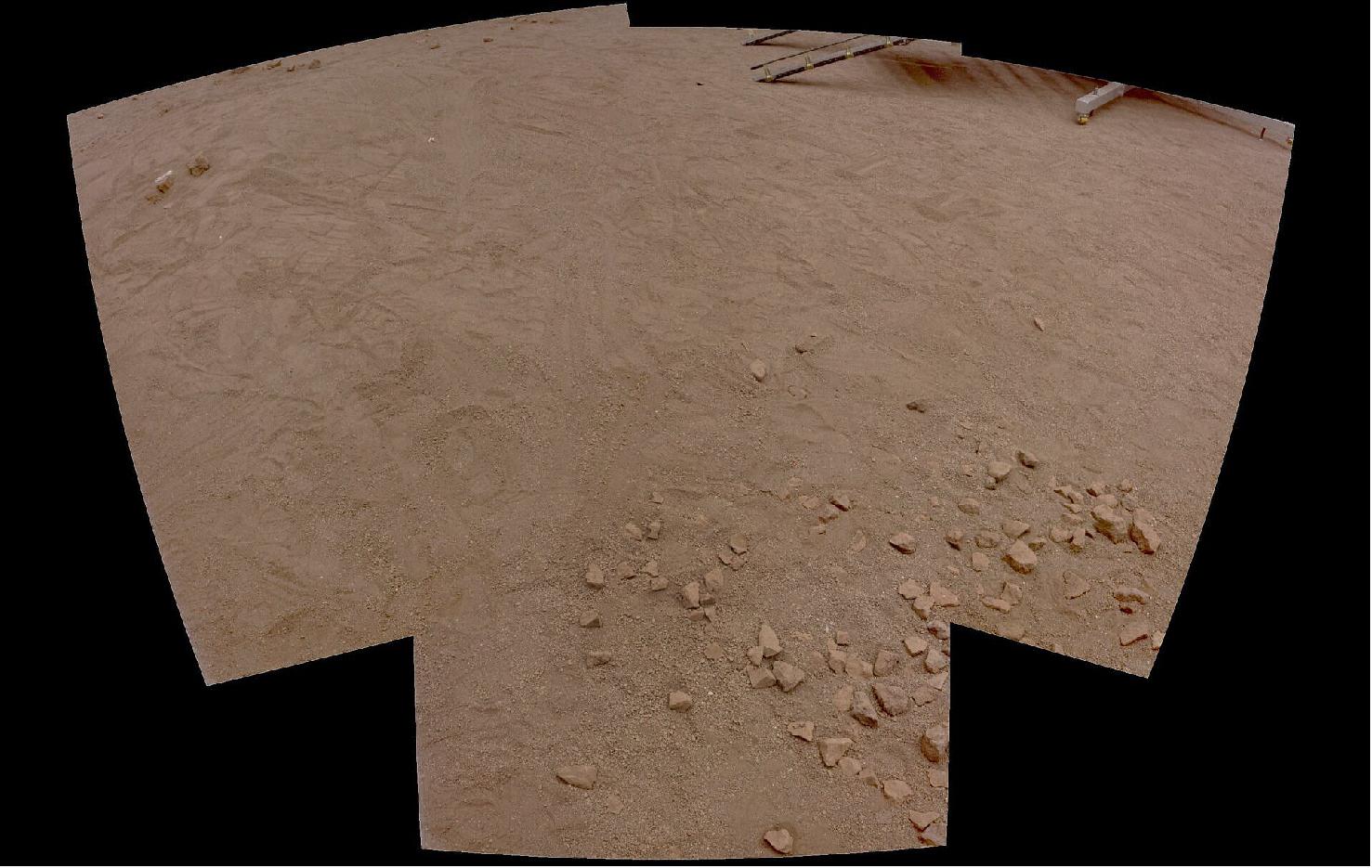 Figure 19: Four images taken by PanCam’s wide-angle cameras were stitched together to form this mosaic of the surface of the Mars Terrain Simulator at the ALTEC premises in Turin, Italy. Some footprints and the legs and ramps of Kazachok landing platform model are visible at the top right. - Color has been determined using three of PanCam’s 11 filters (image credit: ESA/ExoMars/PanCam team)