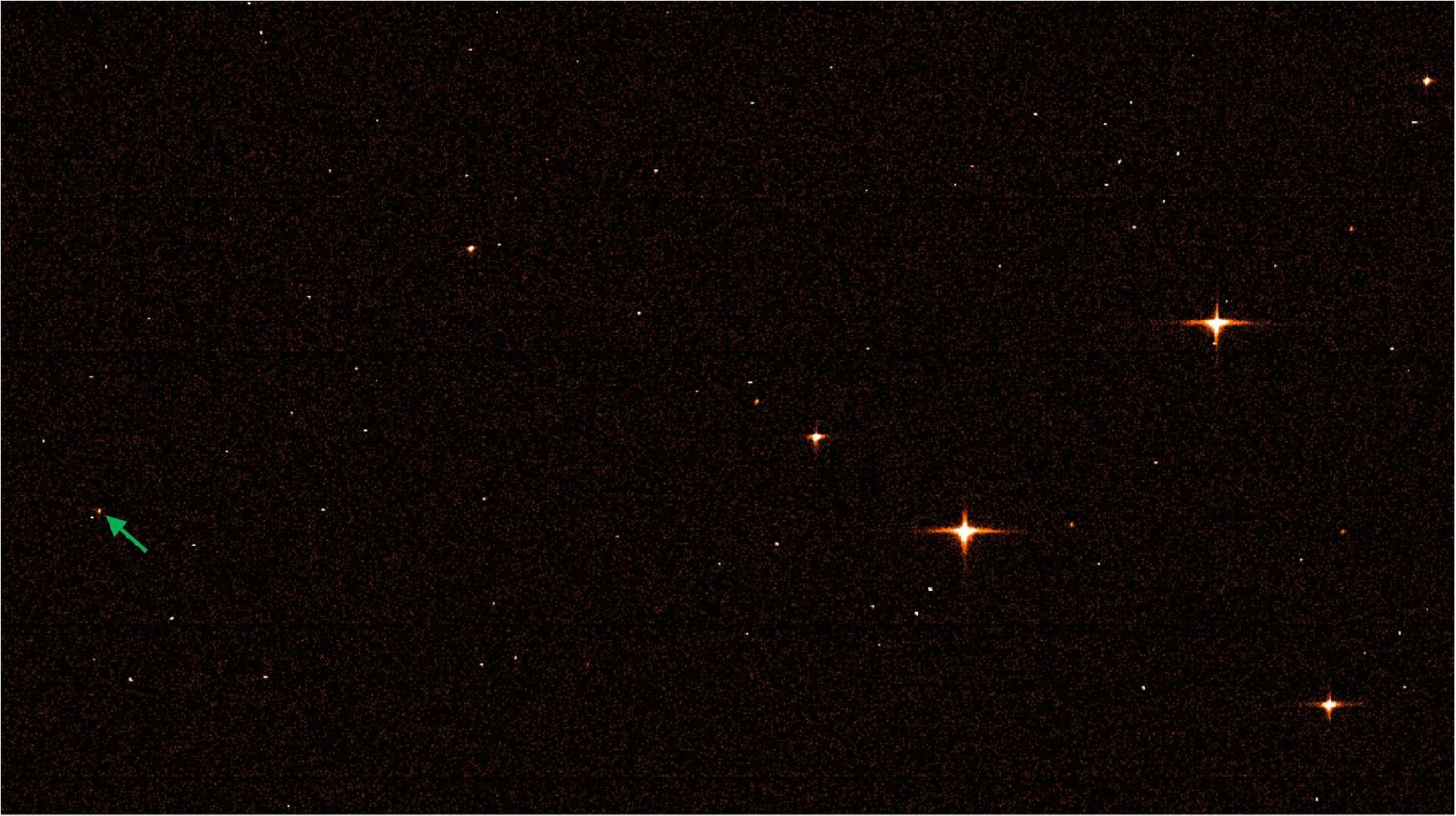 Figure 32: Gaia snaps photo of Webb. Gaia’s sky mapper image showing the James Webb Space Telescope. The reddish colour is artificial, chosen just for illustrative reasons. The frame shows a few relatively bright stars, several faint stars, a few disturbances – and a spacecraft. It is marked by the green arrow (image credit: ESA/Gaia/DPAC; CC BY-SA 3.0 IGO)