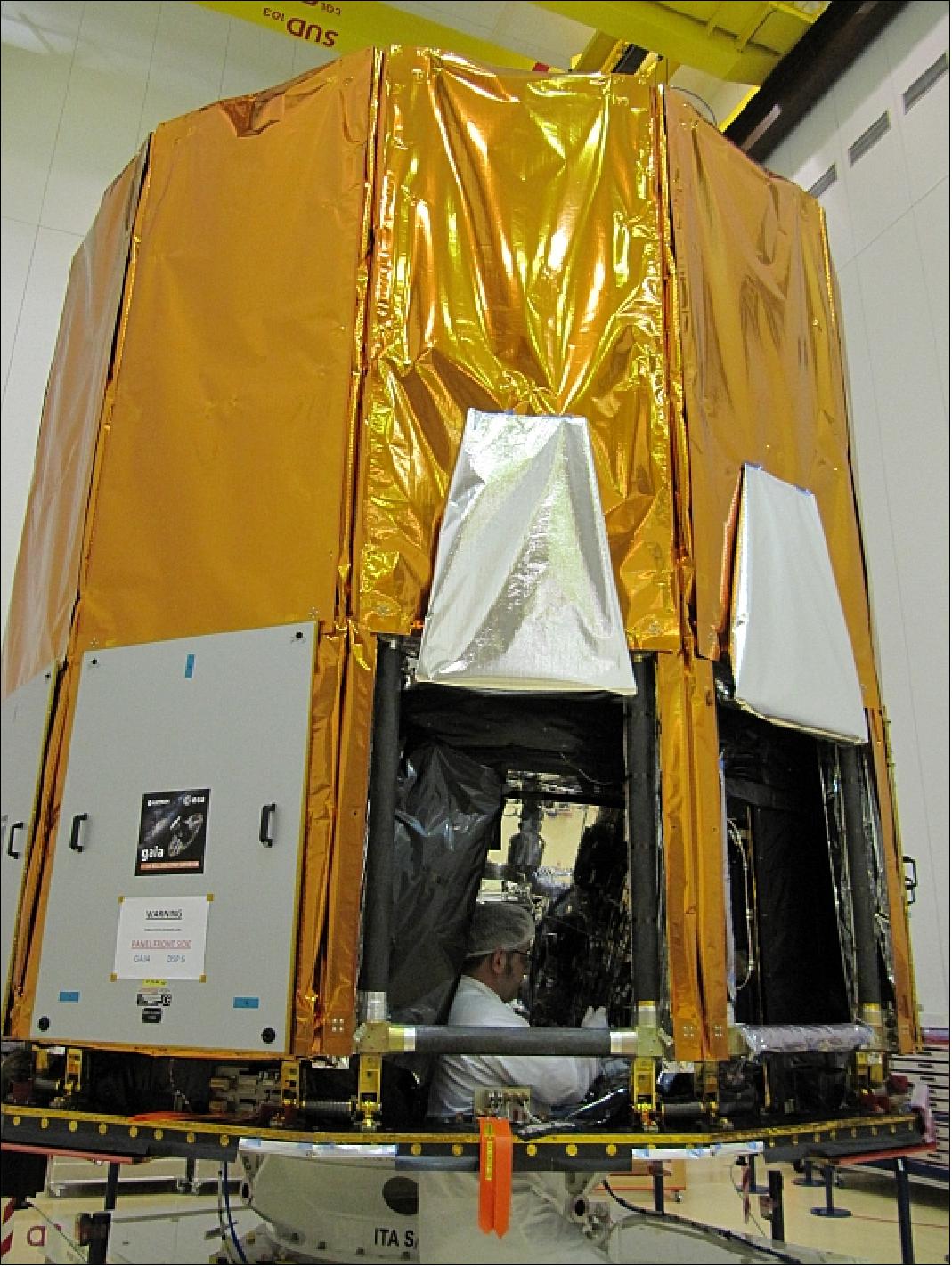 Figure 17: Photo of the Gaia spacecraft in Nov. 2013 with an Astrium AIT engineer installing the transponders at the launch site (image credit: ESA)