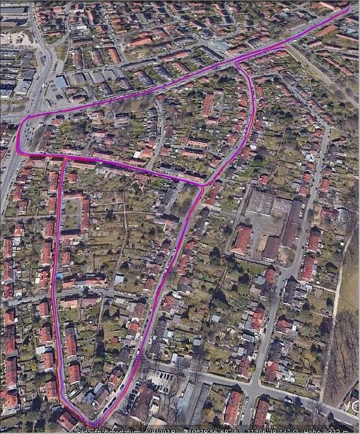 Figure 8: Outdoor automotive testing of AMELIE board in urban area: original Mi 8 smartphone track in red and AMELIE track in purple, held at 30º angle (image credit: TeleOrbit)