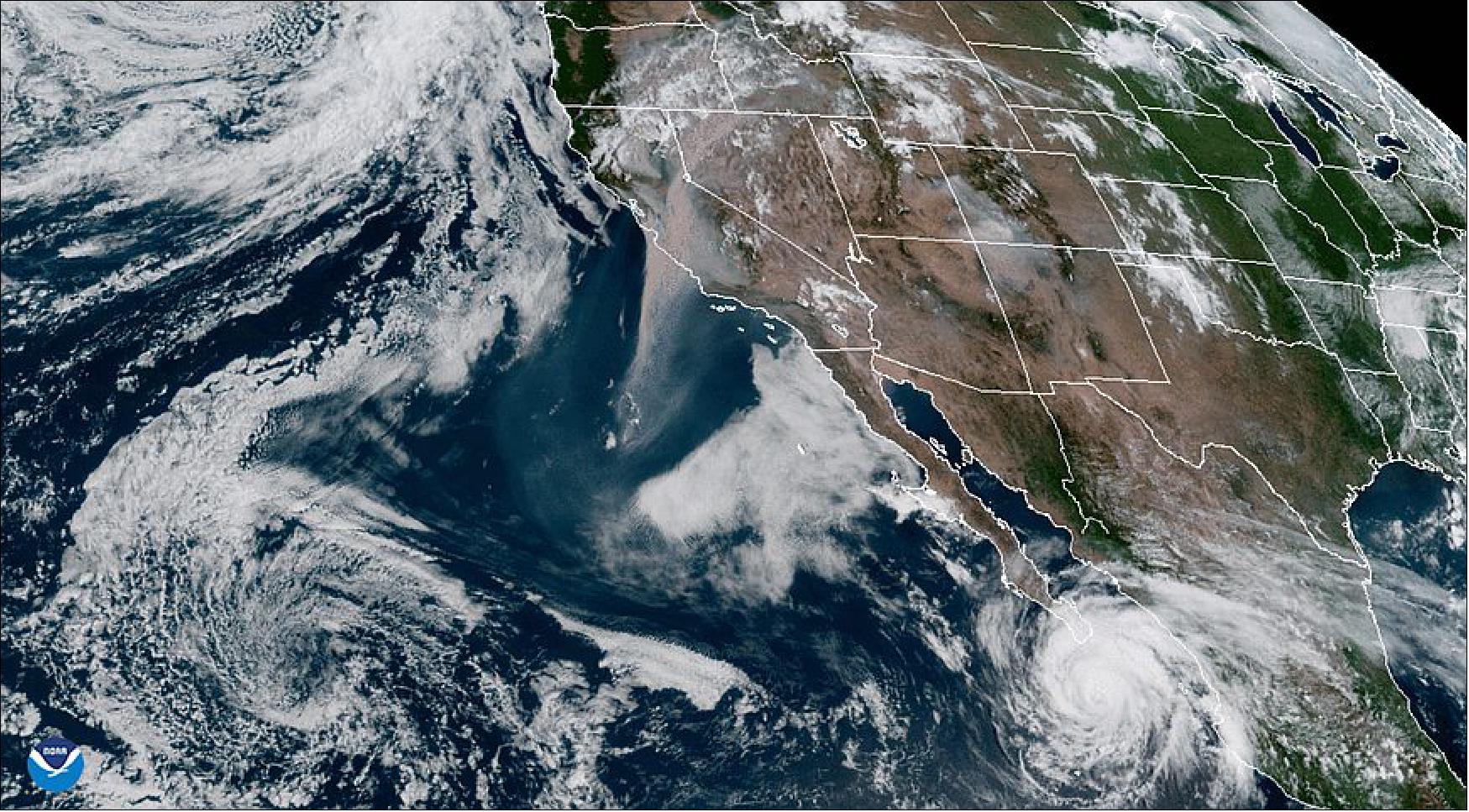 Figure 33: NOAA’s GOES-West satellite (GOES-17) captured the above GeoColor image of massive wildfire smoke plumes billowing from California and areas of the Rocky Mountains on Aug. 19, 2020. To the north, a mid-latitude cyclone spins over the Gulf of Alaska while Hurricane Genevieve continues its path toward Baja California (image credit: NOAA)