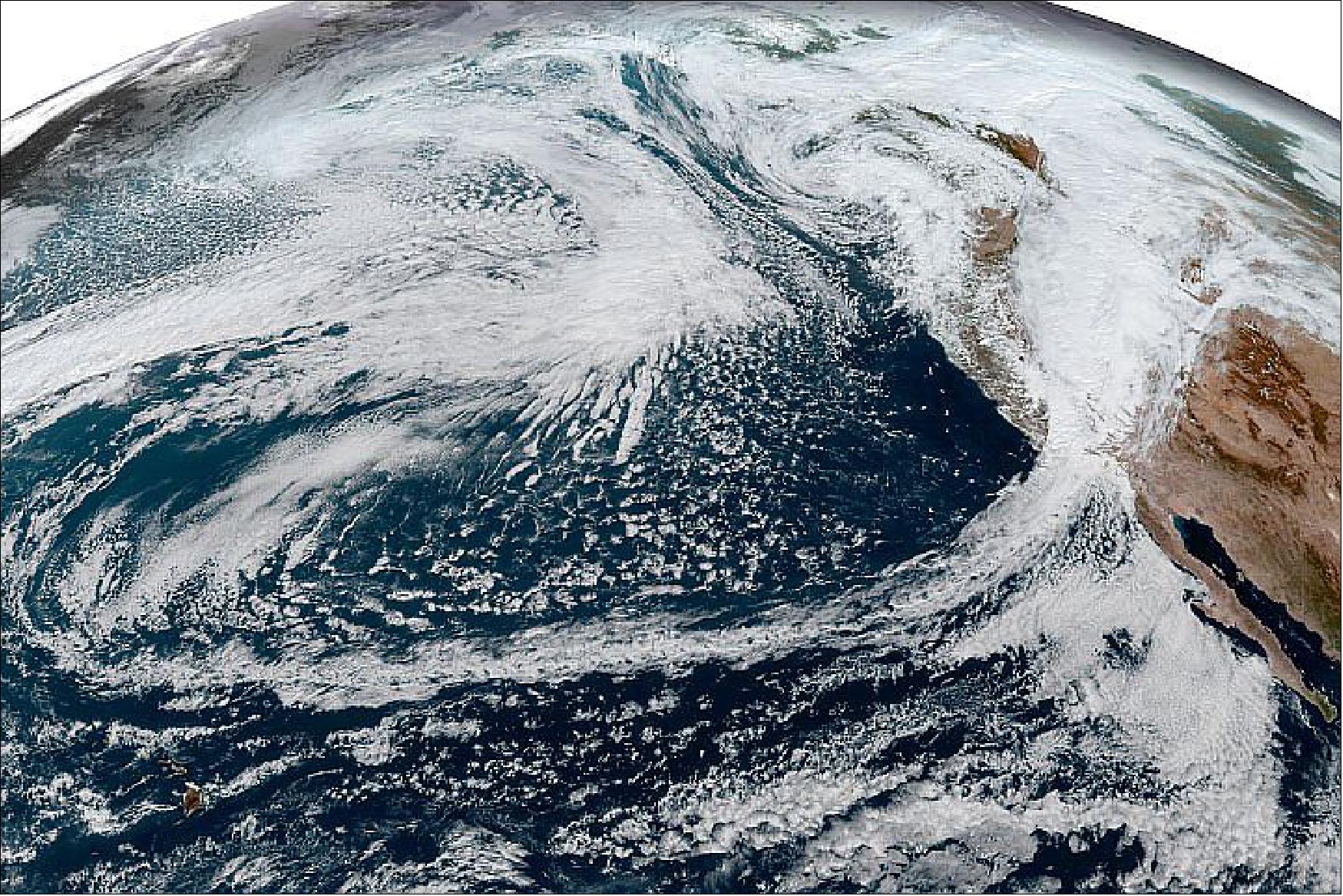 Figure 29: This simulated natural-color image, acquired on October 25 by NOAA’s Geostationary Operational Environmental Satellite 17 (GOES-17) shows an arc of clouds stretching across the Pacific—a visible manifestation of the atmospheric river pouring moisture into the Pacific Northwest. GOES-17 is operated by the National Oceanic and Atmospheric Administration (NOAA); NASA helps develop and launch the GOES series of satellites (image credit: NASA Earth Observatory)